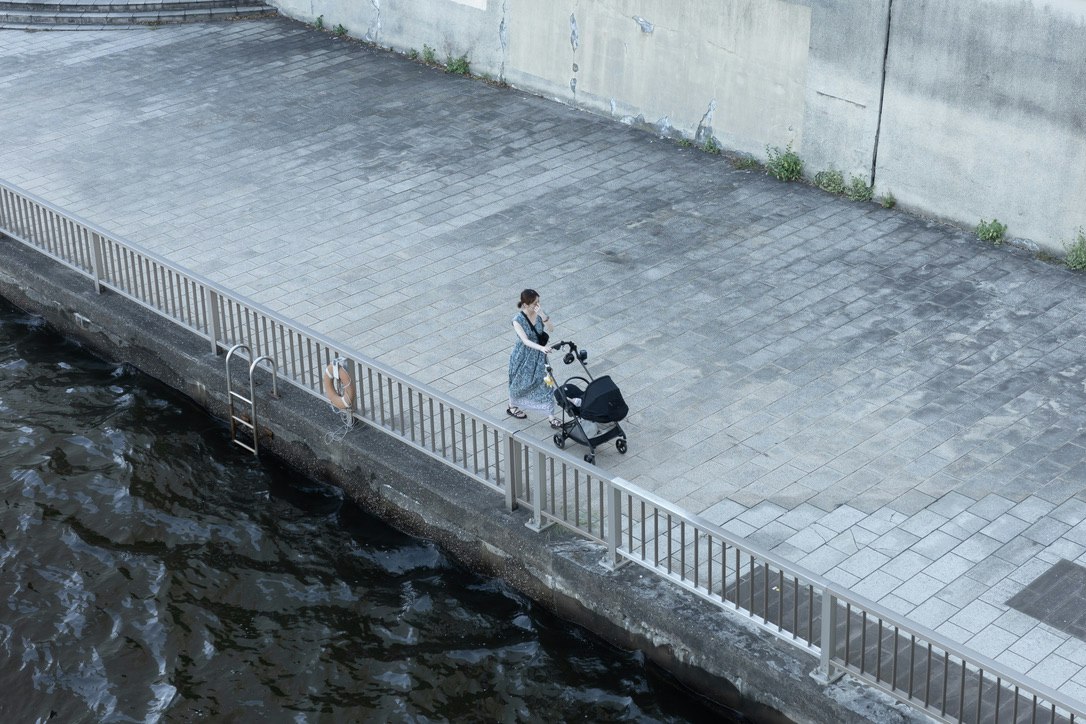 motorbike and pedestrian on a riverside promenade