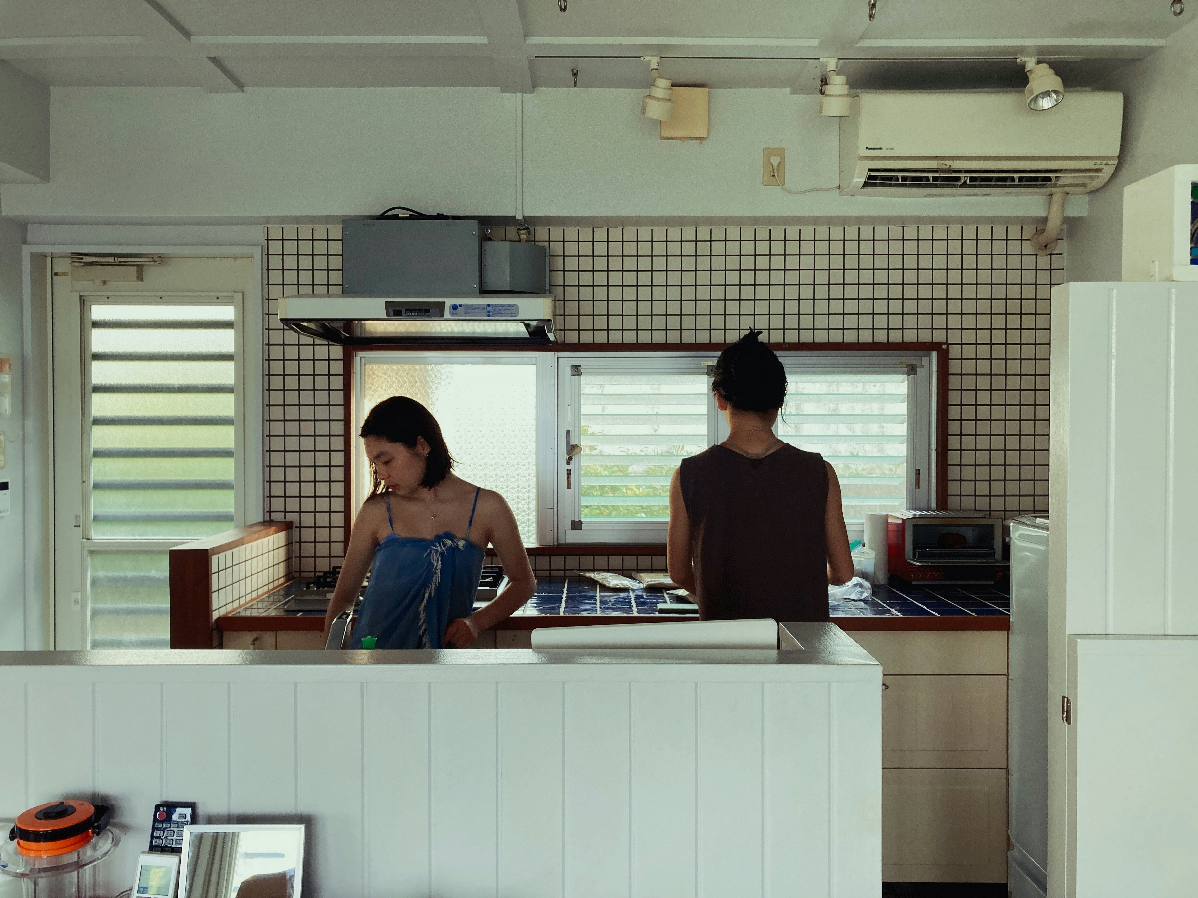 two people chatting at a kitchen counter