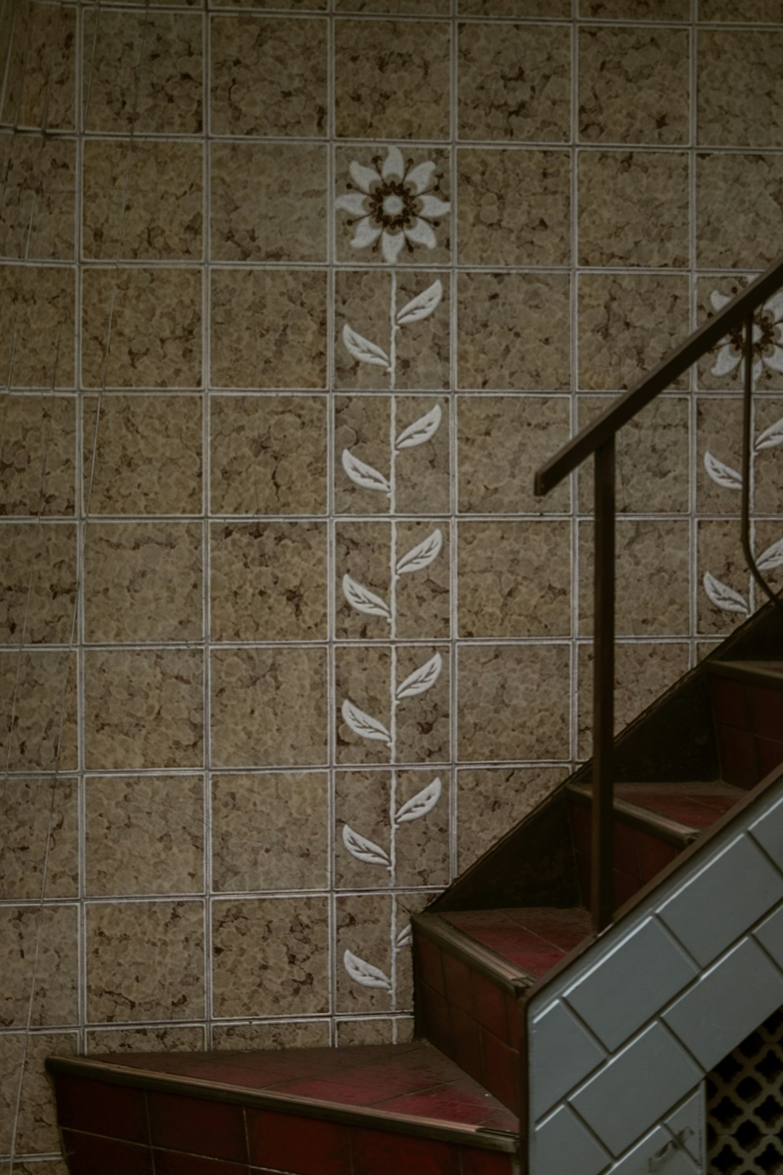 Decorative tiles with floral design on staircase wall