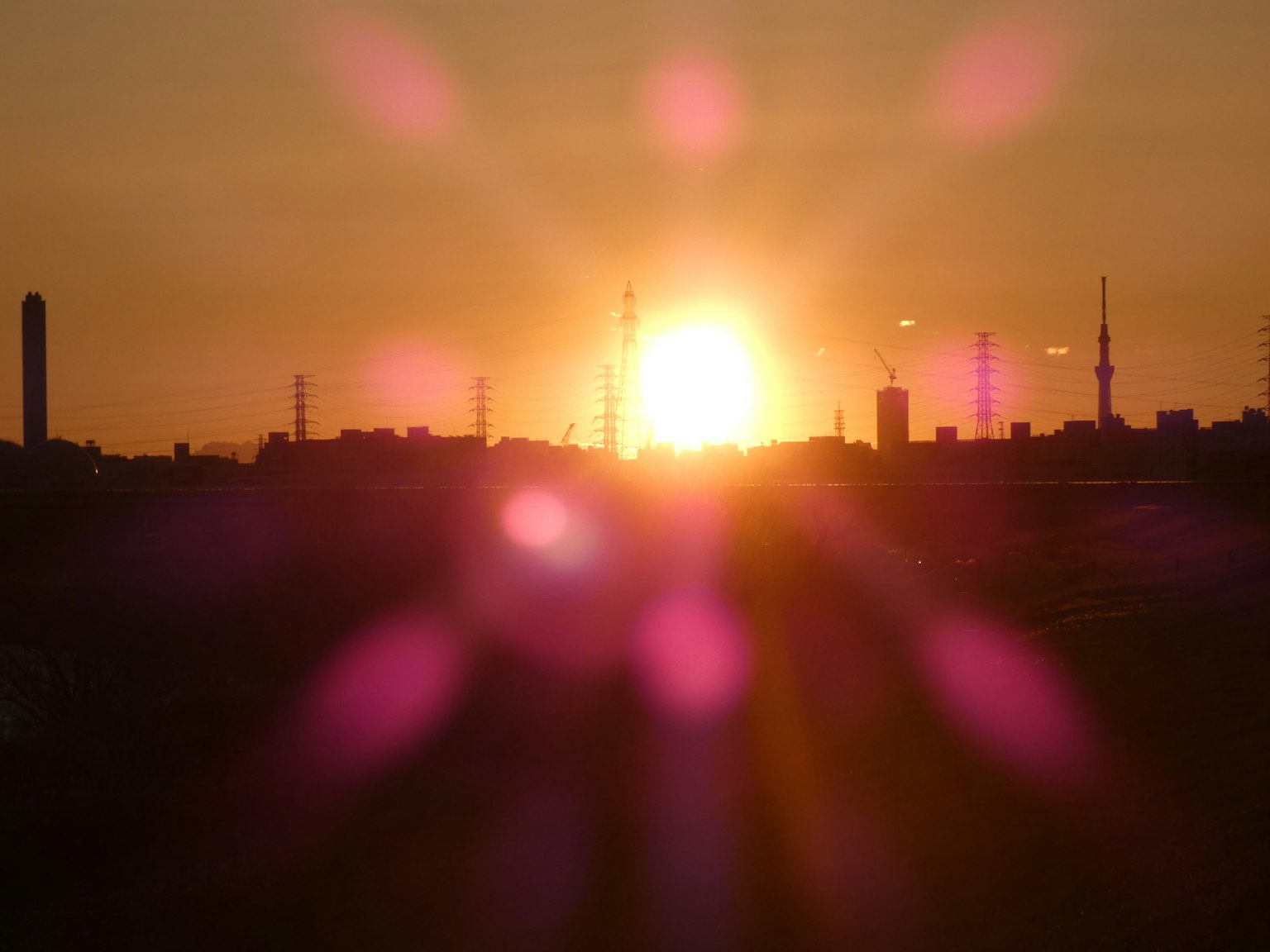 A stunning sunset illuminating city silhouettes with visible radio towers