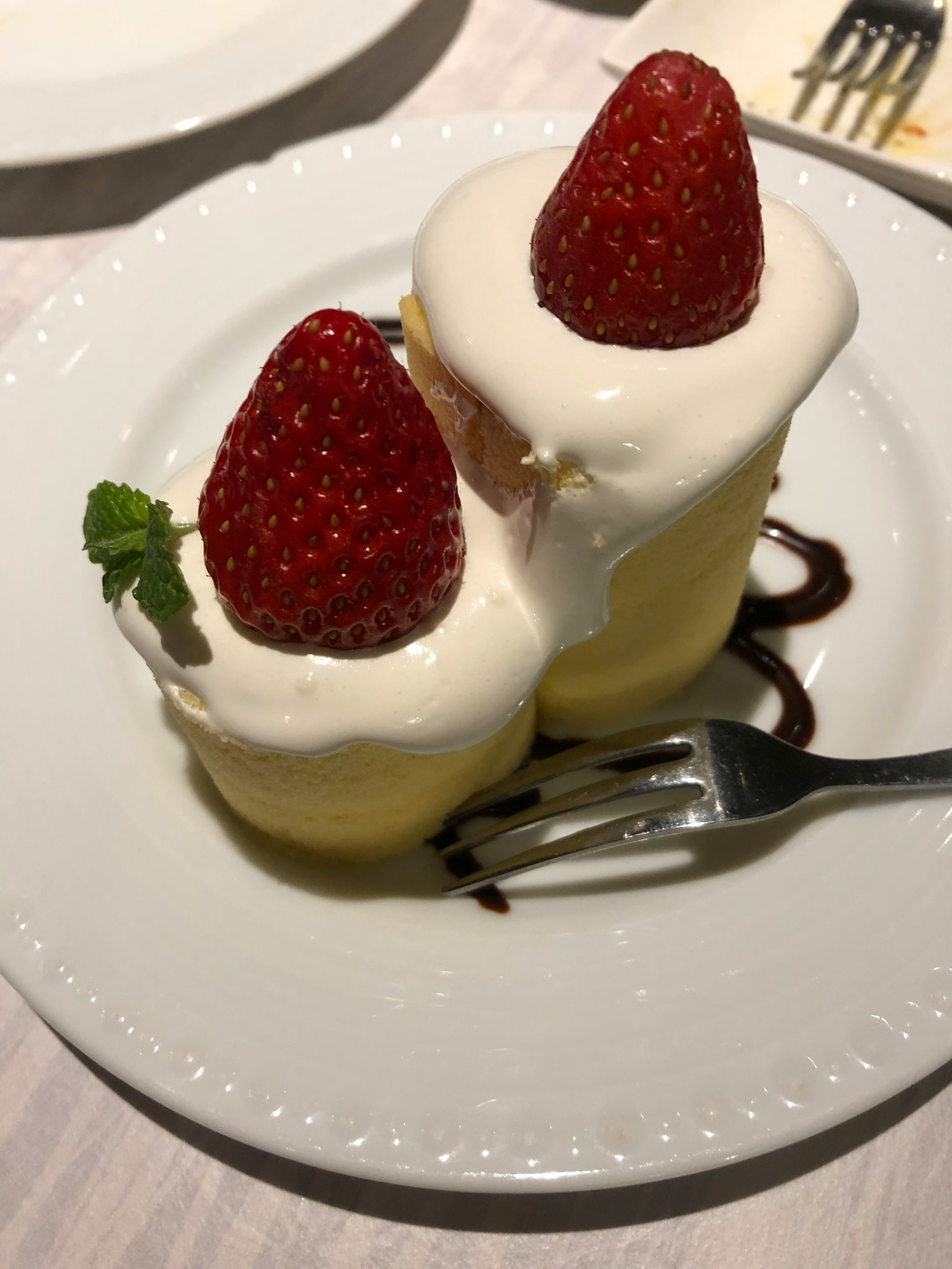 Dessert with strawberries and cream on a plate