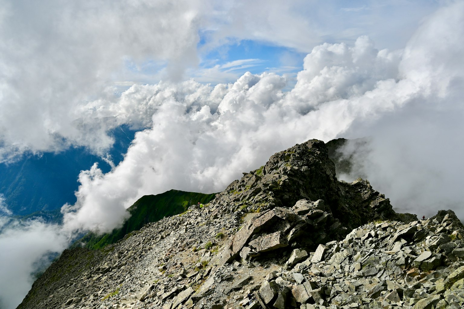 Mountain rocky terrain with clouds and visible blue sky