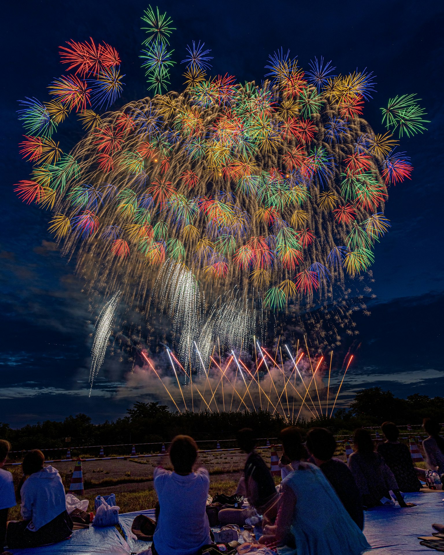 Colorful fireworks display lighting up the night sky with spectators enjoying the view