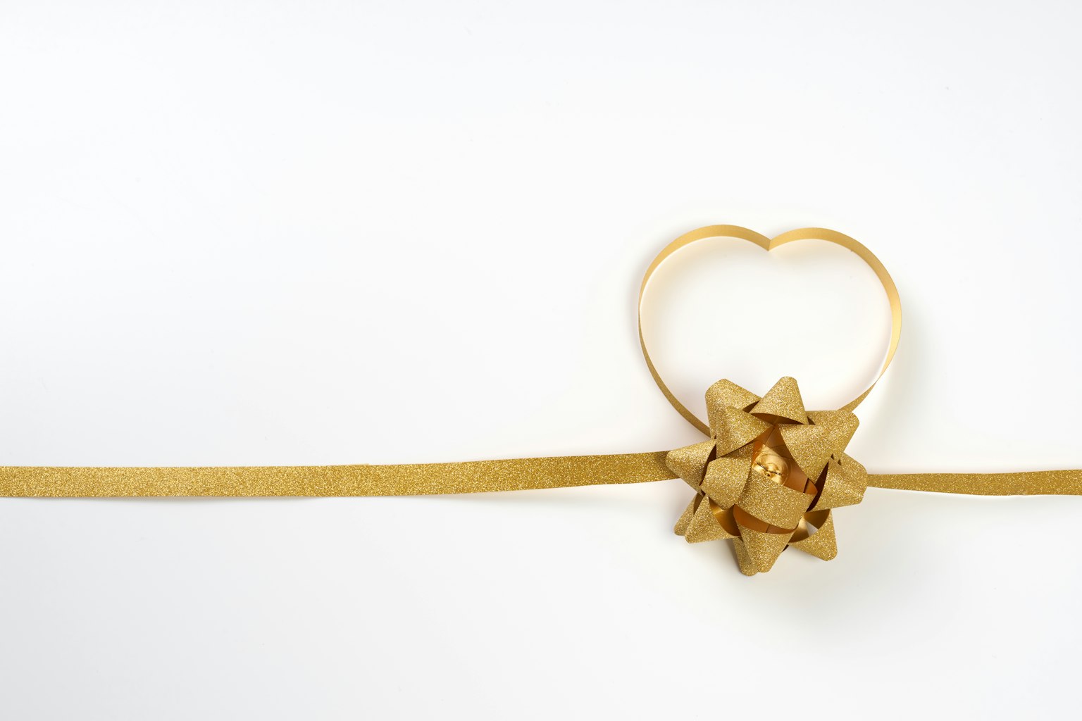 Decorative golden ribbon with a heart-shaped bundle