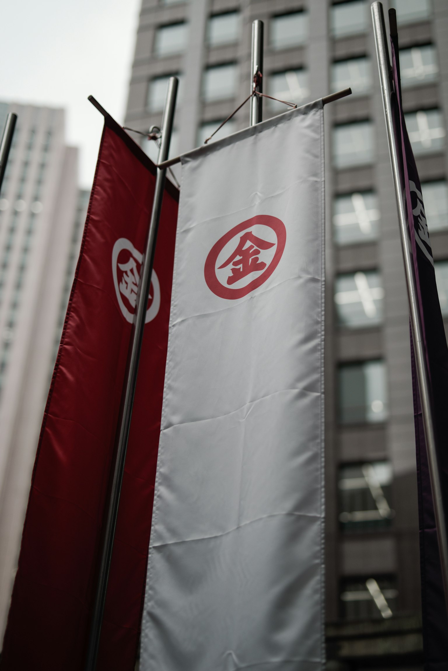 Red and white flags displayed in an urban setting