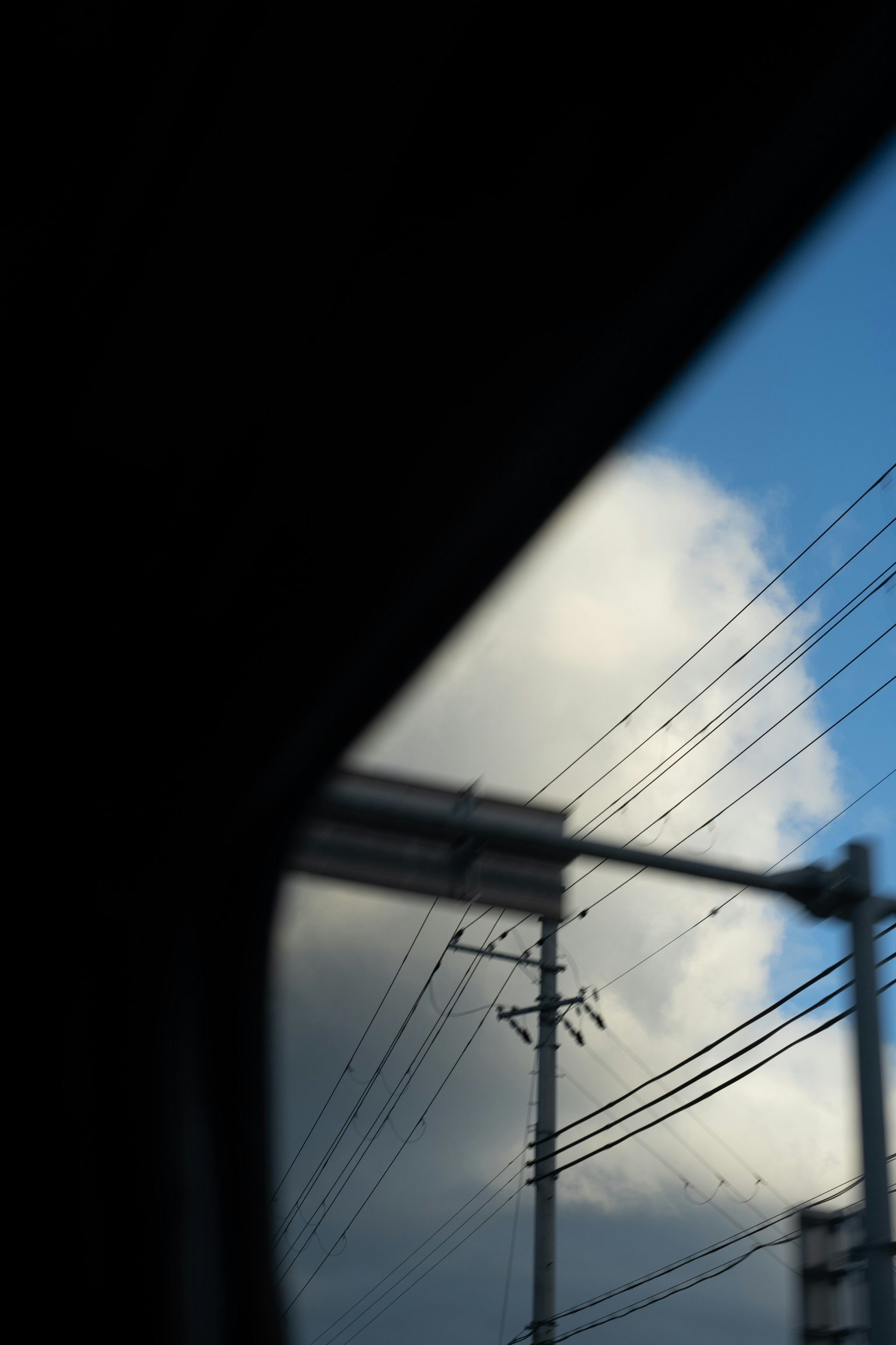 upward view of power lines against the sky
