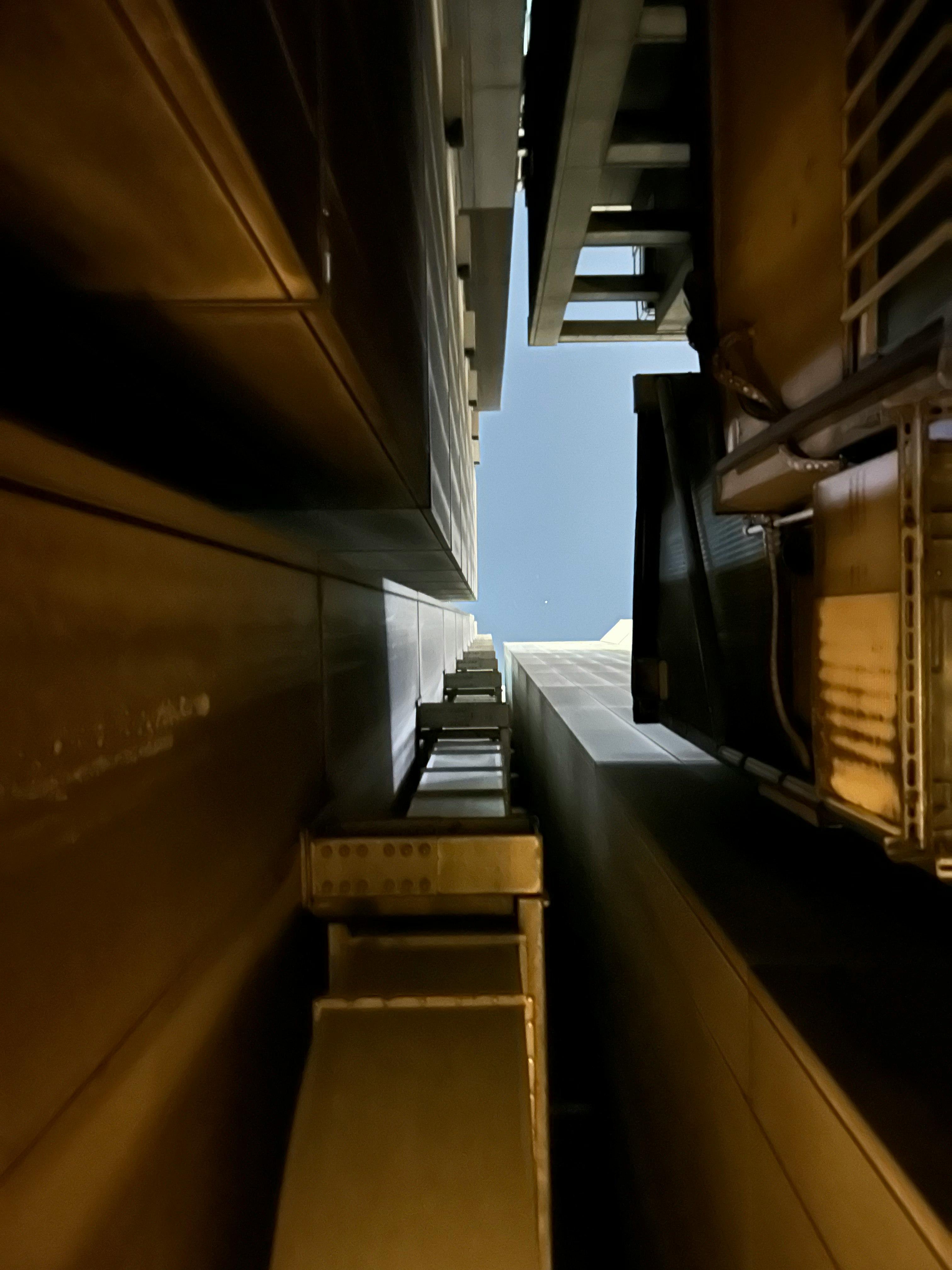 upward view into a narrow alley between buildings
