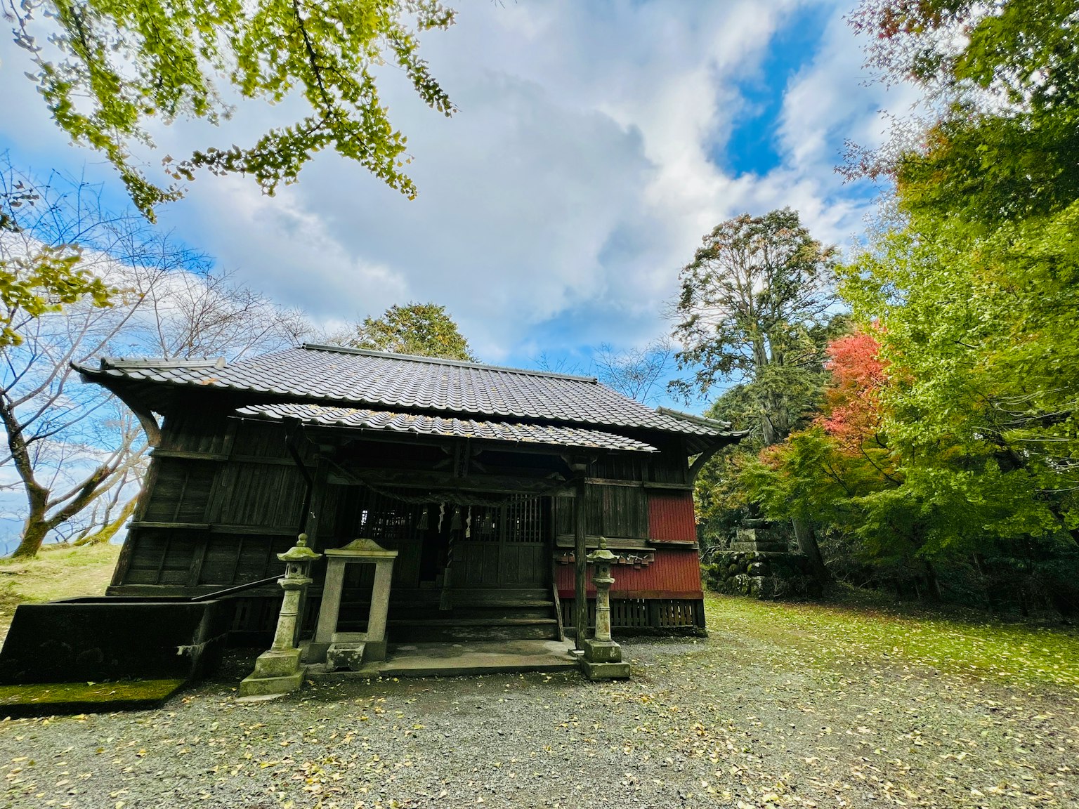 An old shrine building standing in a spacious green area
