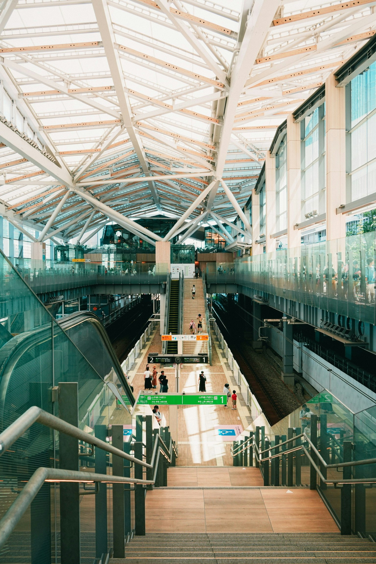 indoor staircase and walkway inside a glass-roofed atrium