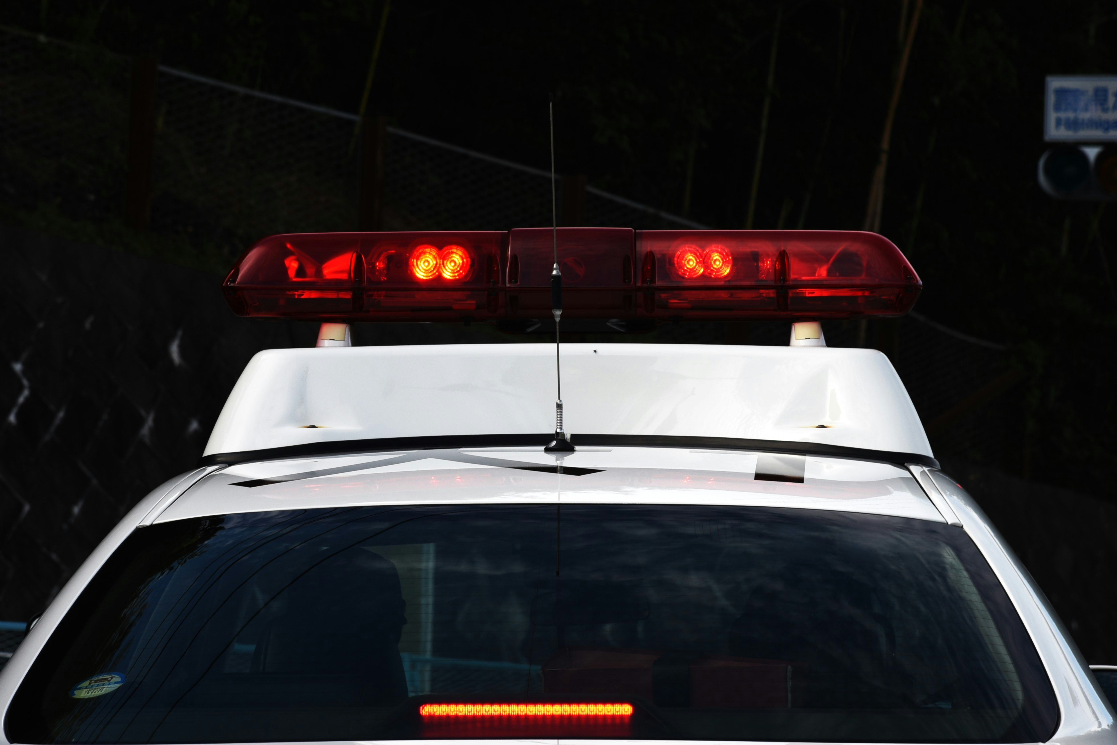 紅色警燈閃爍的警車車尾