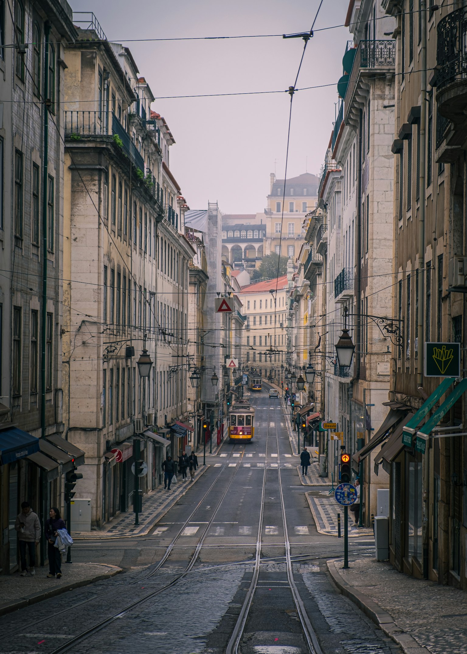 Quiet street view of Lisbon with visible tram tracks