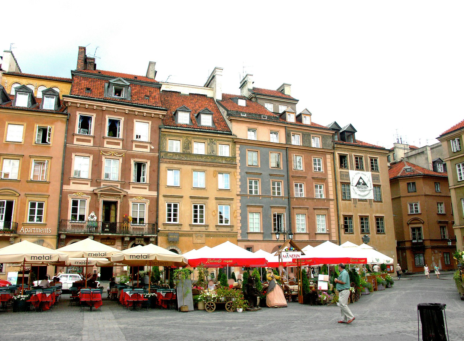 A vibrant square with colorful buildings and outdoor dining
