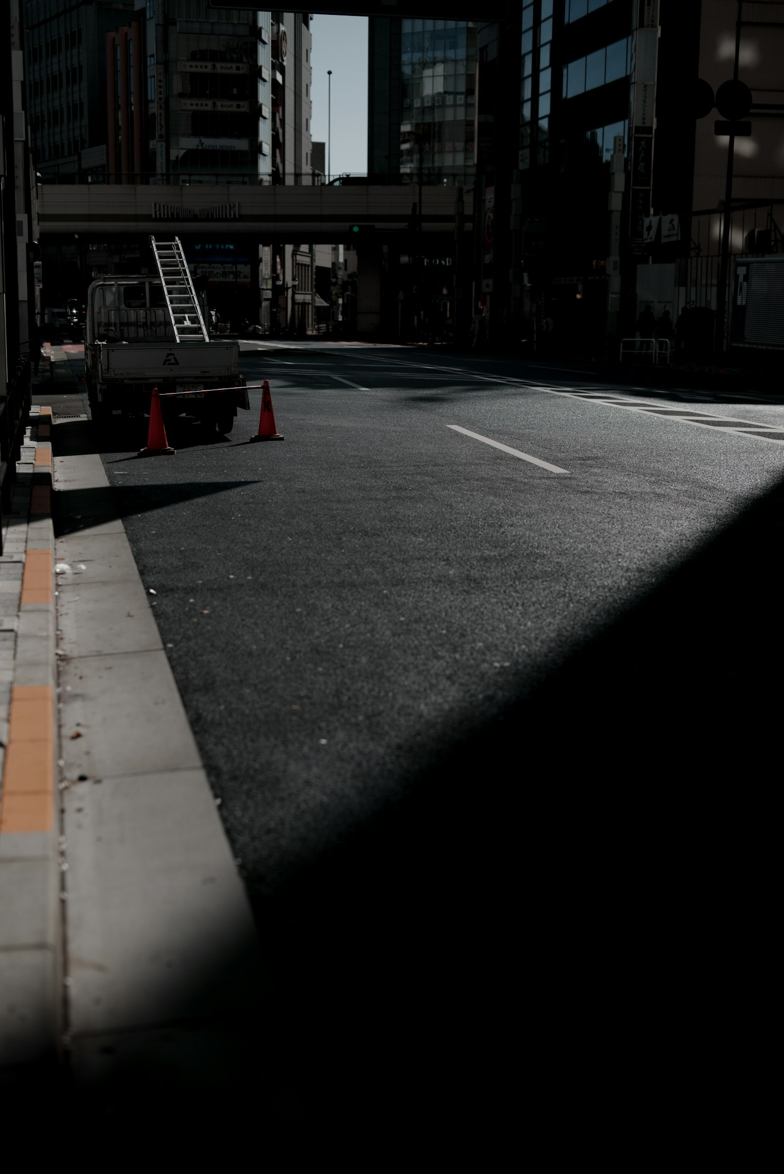Ladder and cones on a dark city street