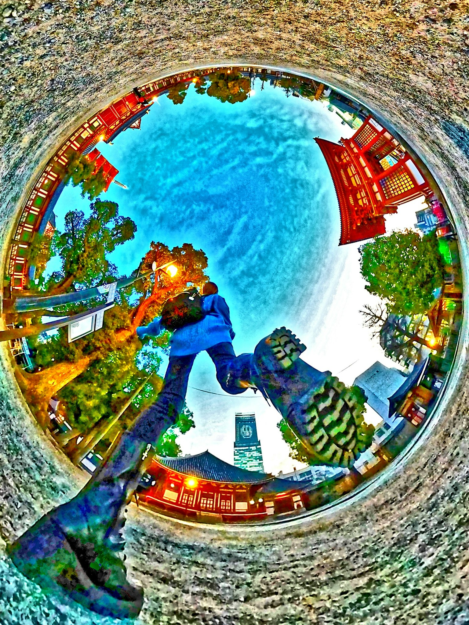 Panoramic view of a park featuring an old temple and colorful buildings