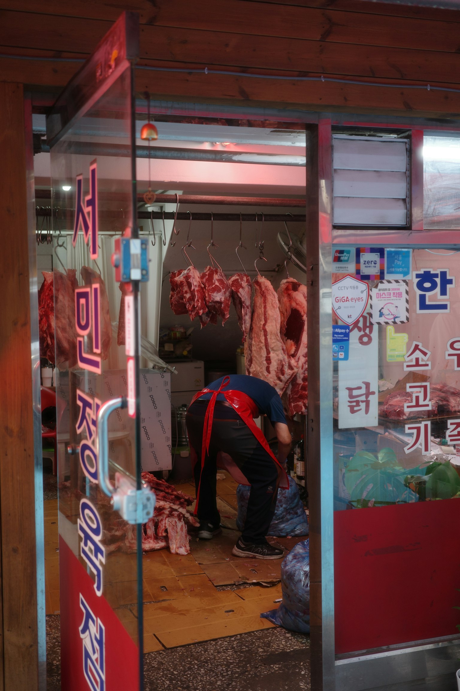 Exterior of a butcher shop with a person working inside