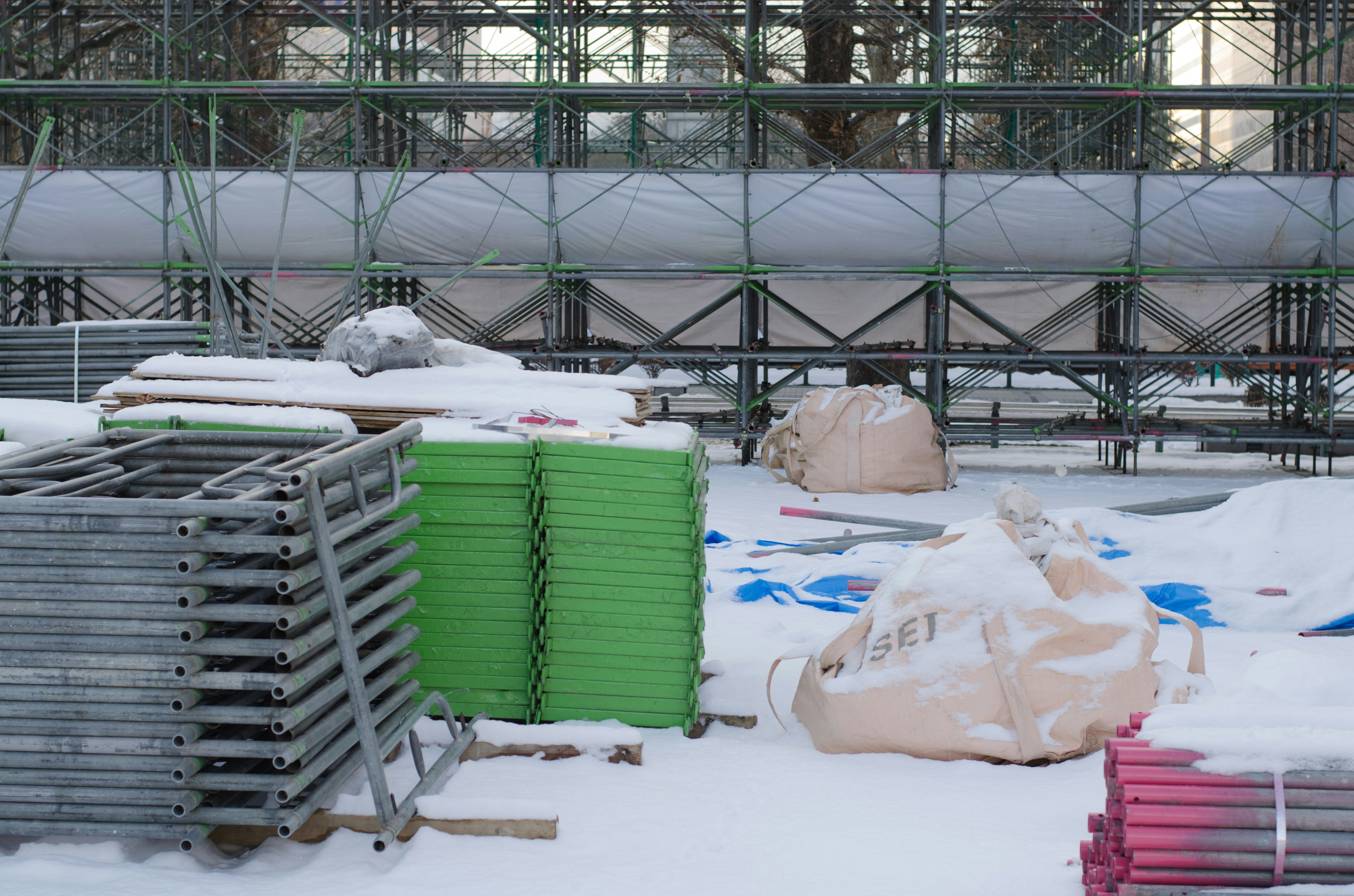 outdoor storage yard with snow-covered materials and containers