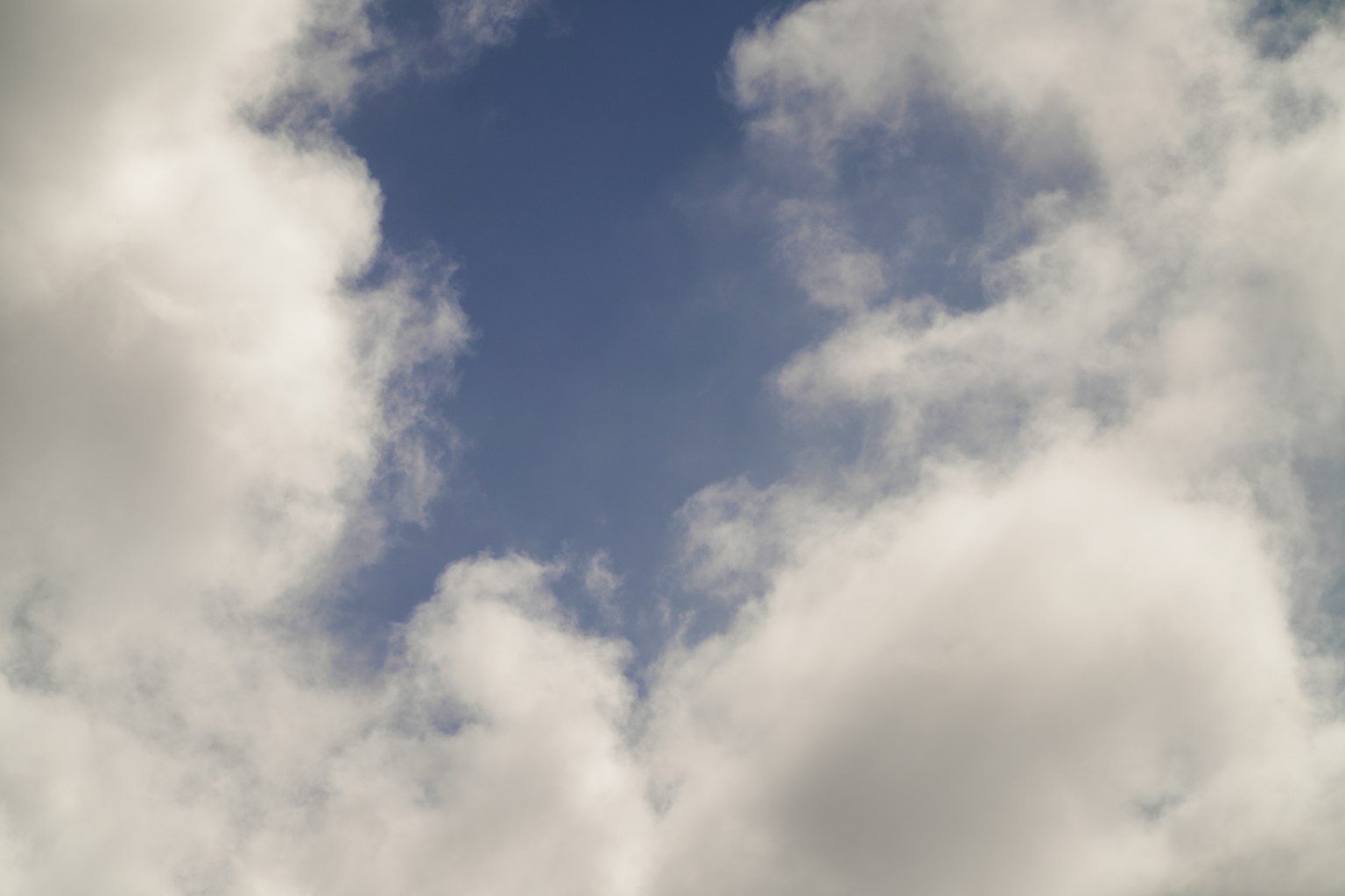 A view of blue sky with fluffy white clouds