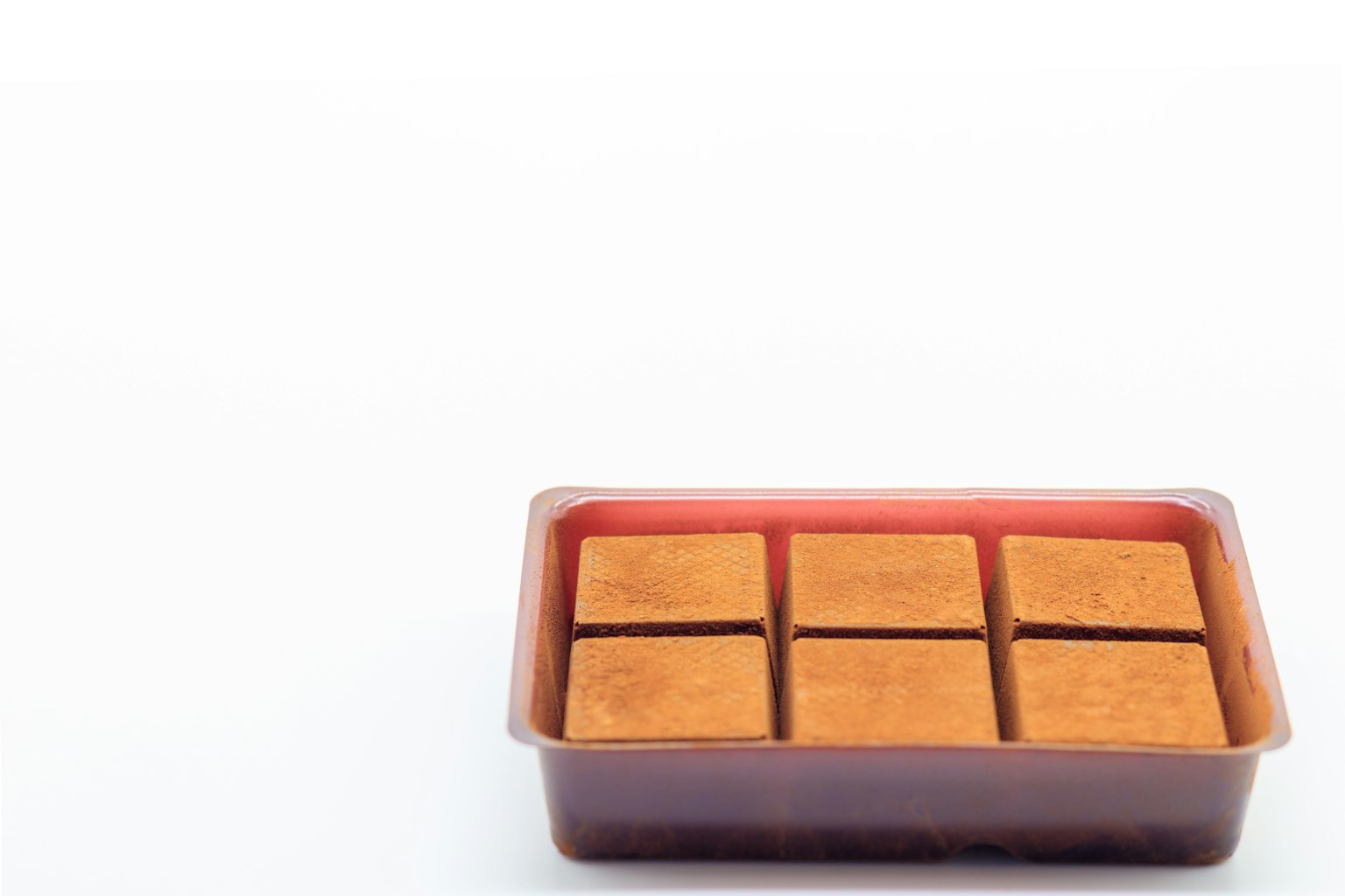 Plastic container with six rectangular chocolate pieces