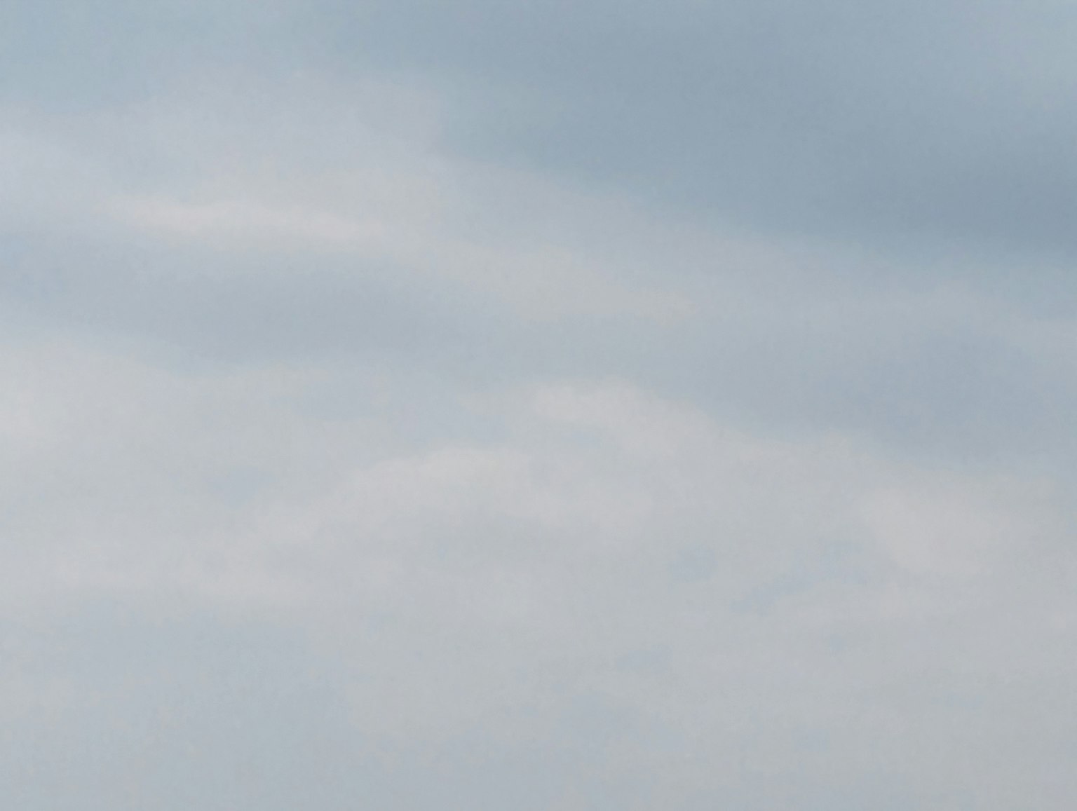 A serene sky with soft clouds in shades of blue