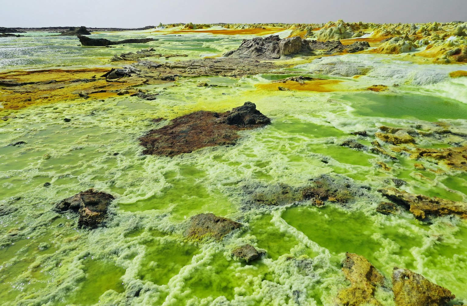 Landscape with greenish yellow ground and rocky formations