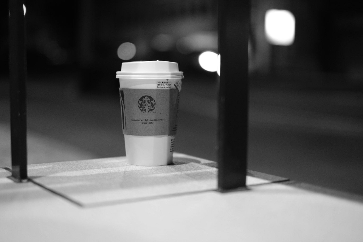 Starbucks-Kaffeebecher auf einem Tisch in einer nächtlichen Umgebung