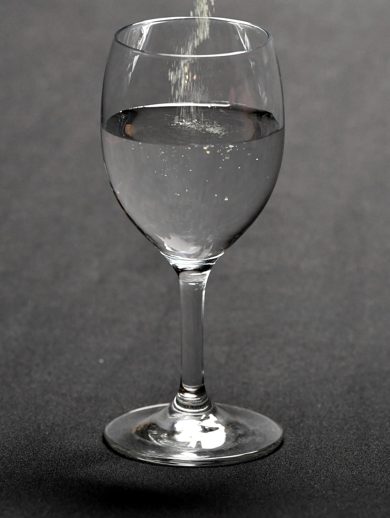 Scene of water being poured into a clear glass