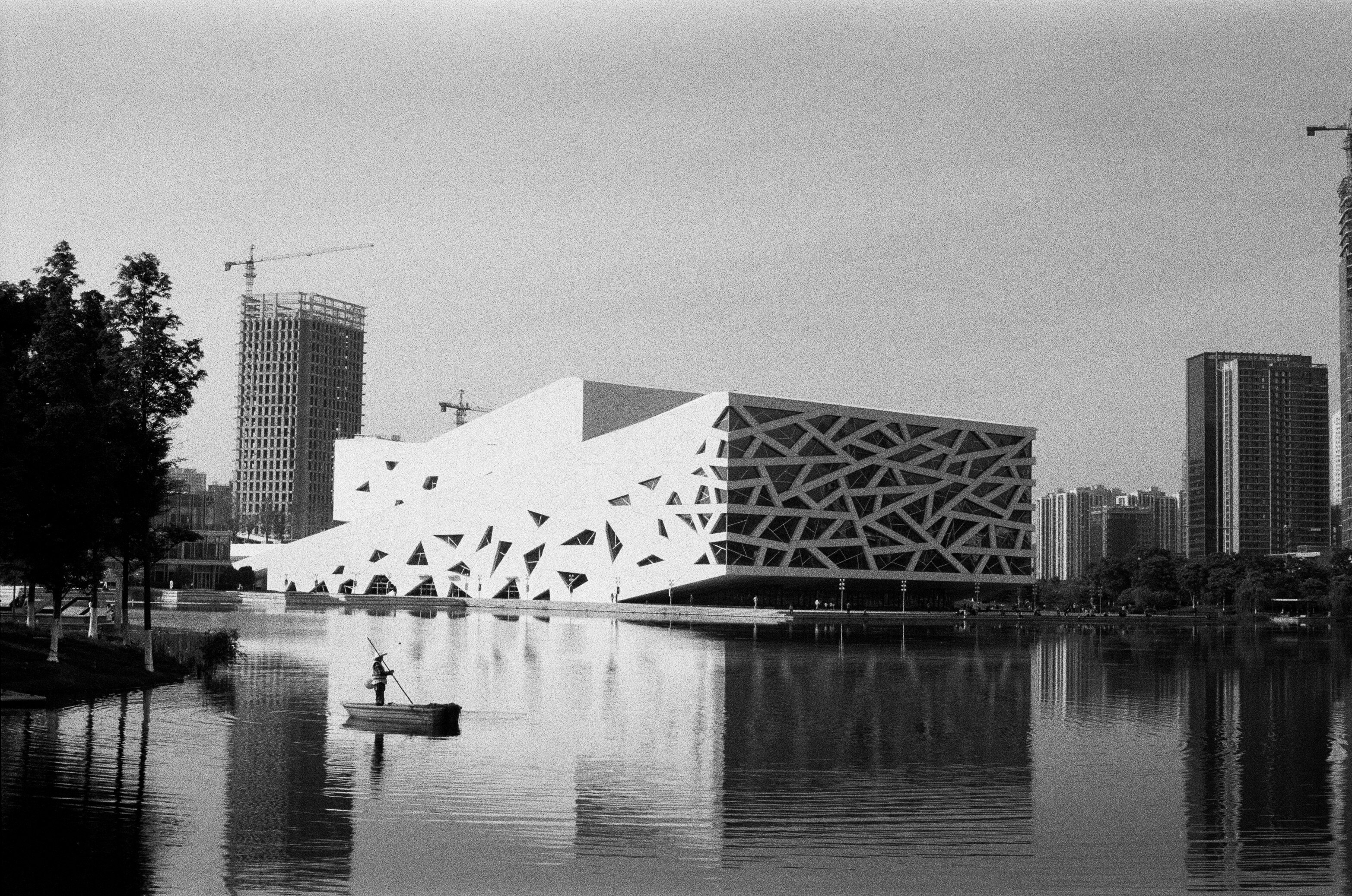 modern riverside building reflected in calm water