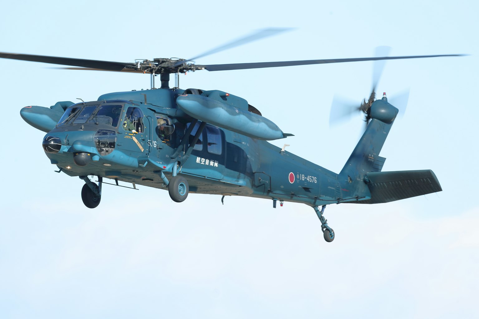 Blue helicopter flying in the sky
