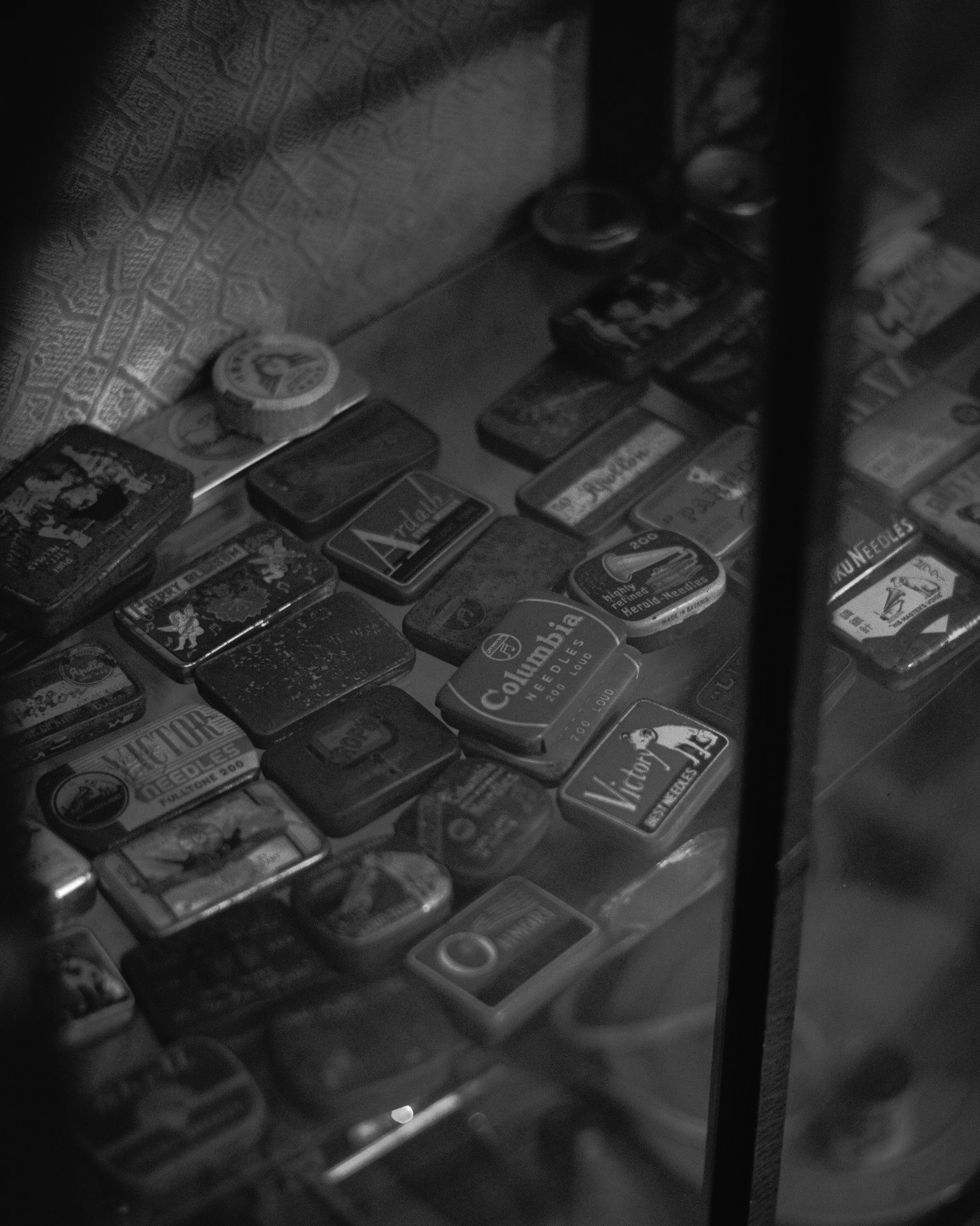 A collection of various small items with unique designs displayed in a glass case