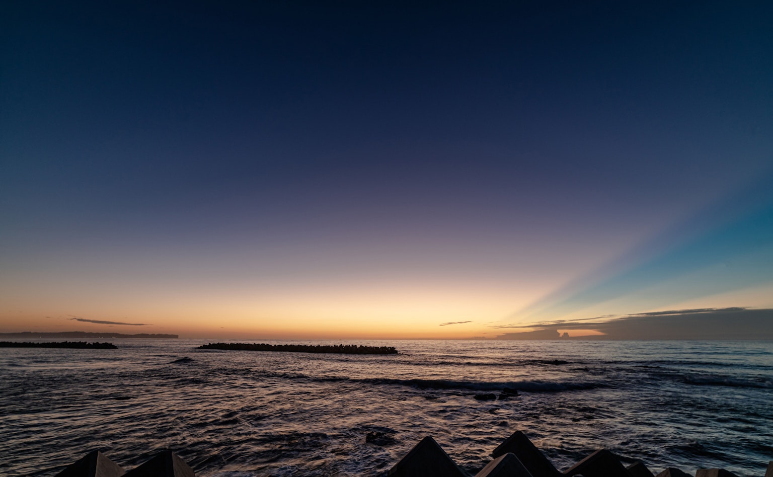 Beautiful sunset landscape over the sea calm waves lapping against the shore