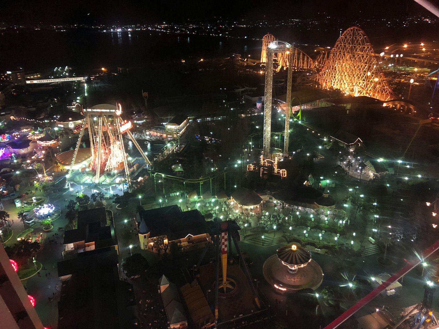 夜間遊樂園的鳥瞰圖，特色多彩的燈光和遊樂設施
