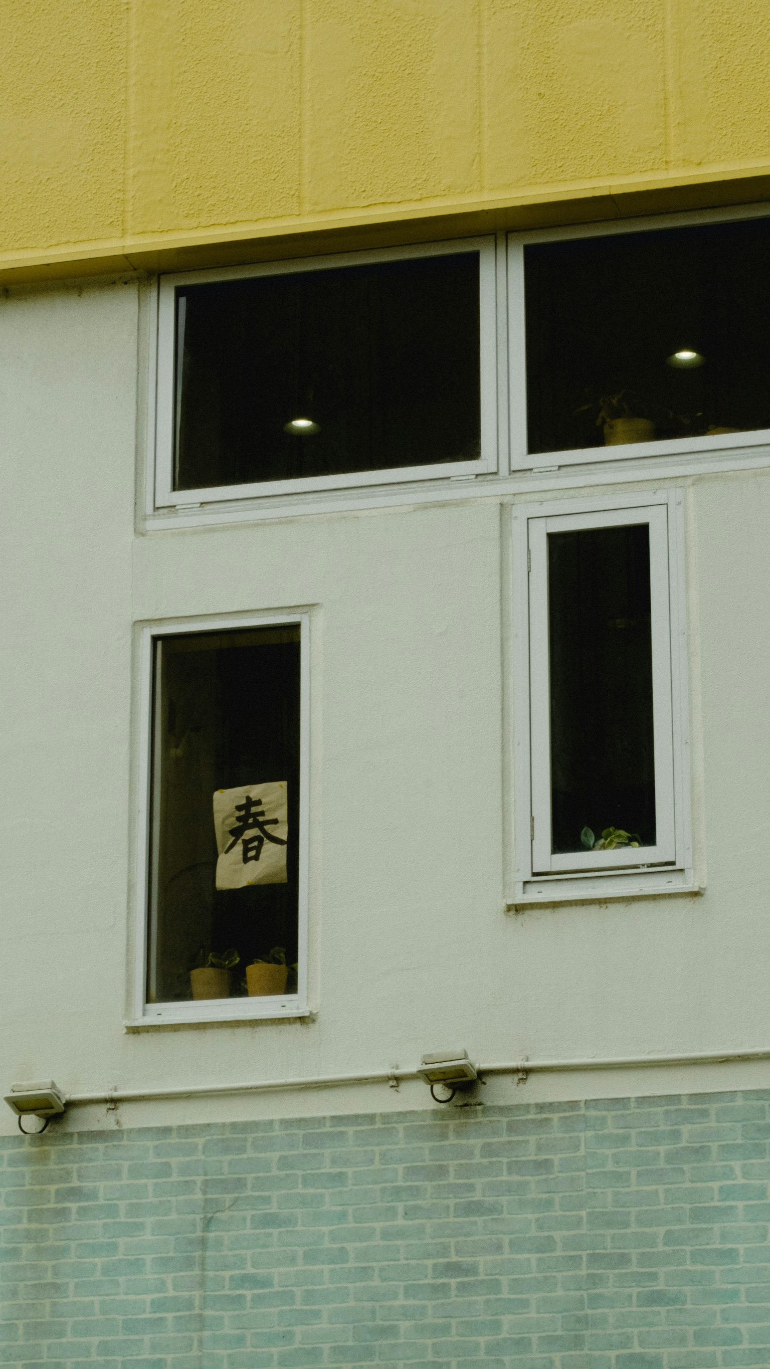 Decorative room with items visible in windows of a yellow building