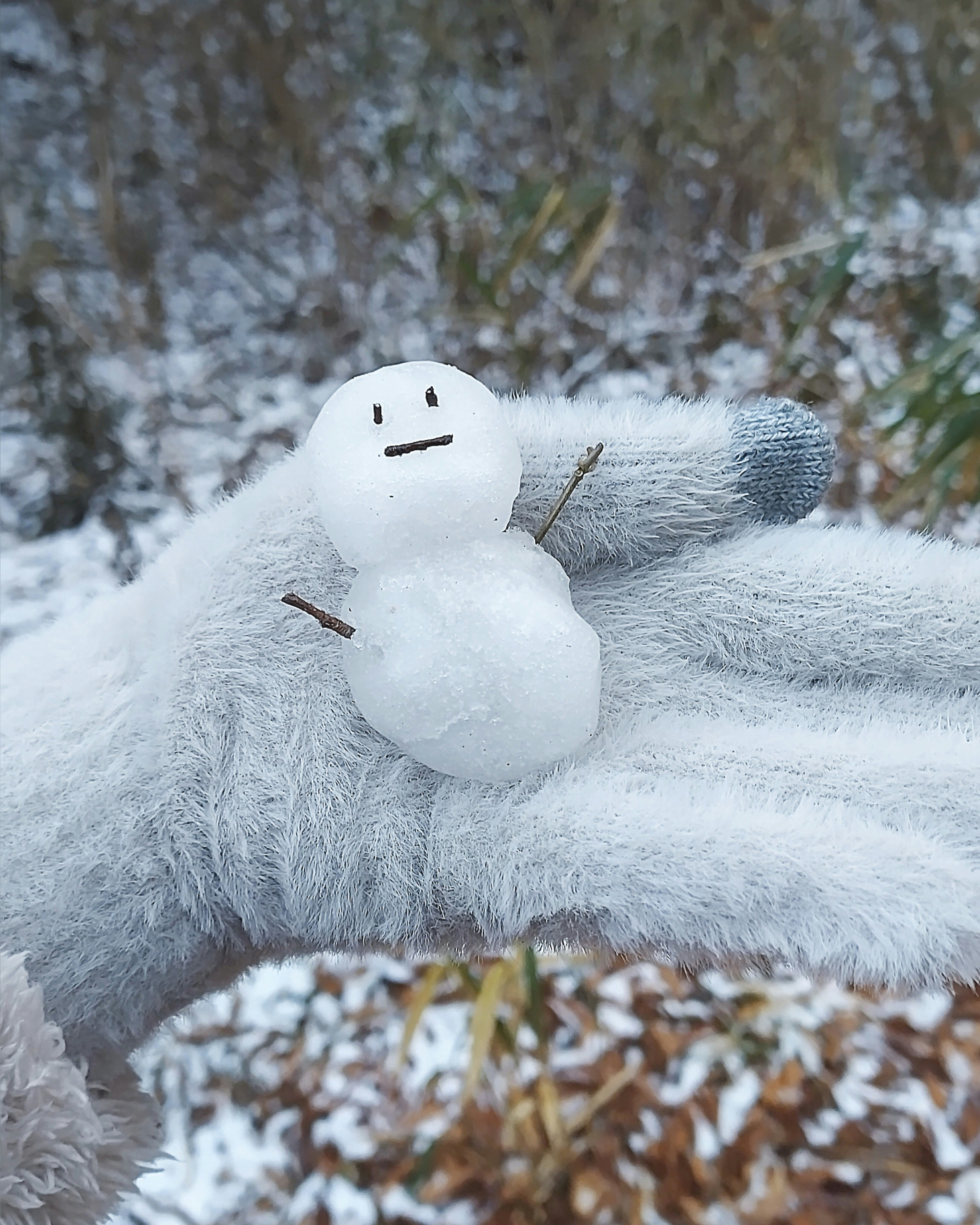 stuffed snowman plush cuddling on snow