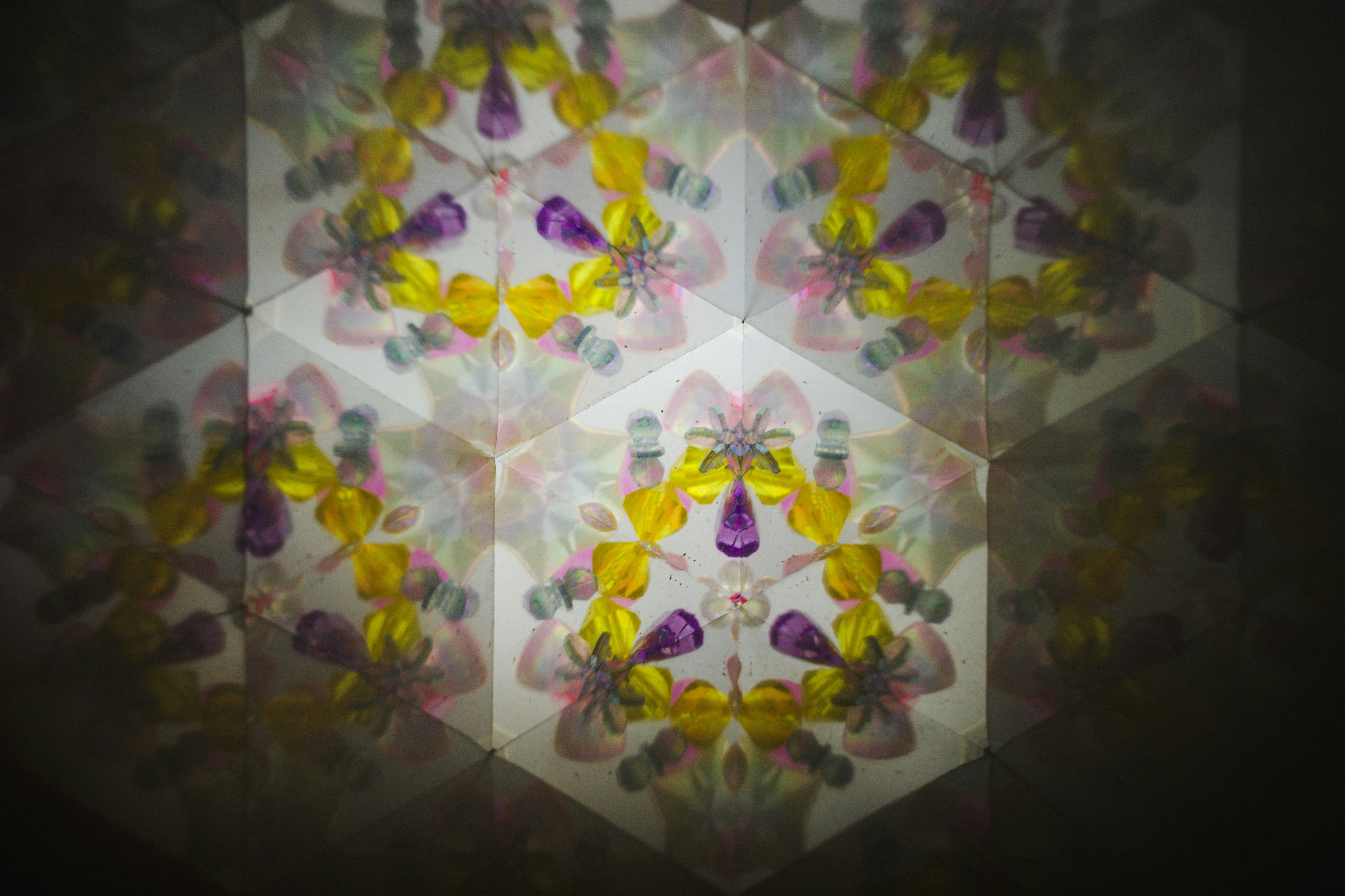 kaleidoscopic geometric pattern with colorful butterfly motifs