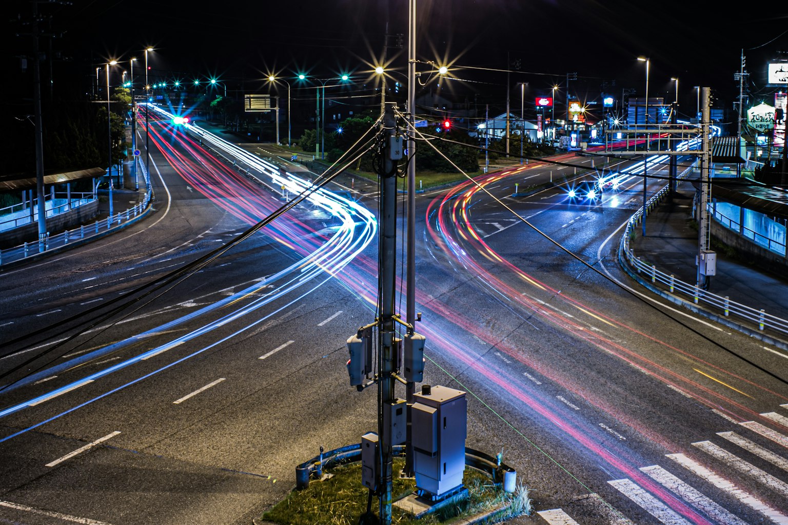 Night scene of an intersection with light trails and traffic signals