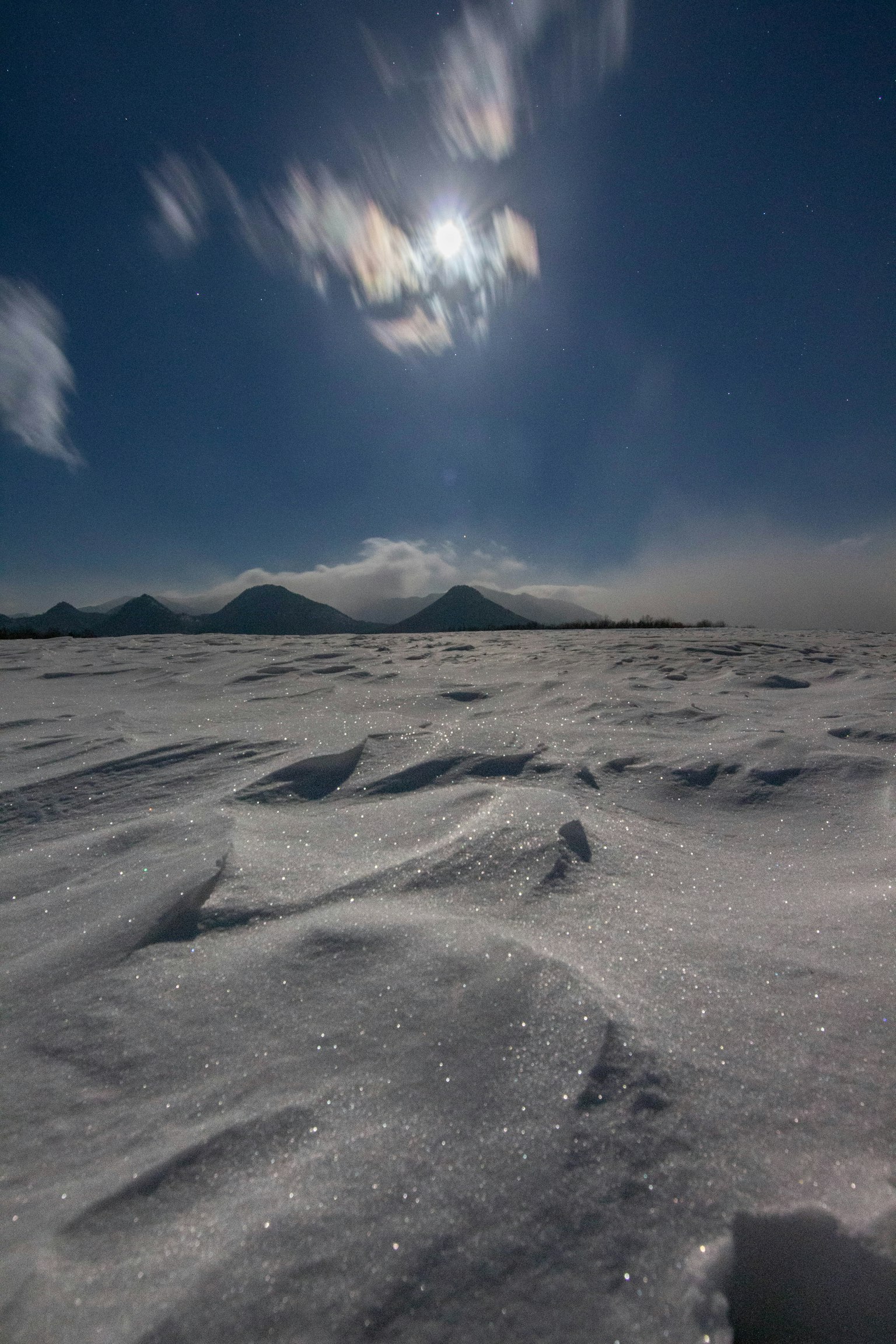 Paysage couvert de neige avec des nuages et le soleil dans le ciel bleu