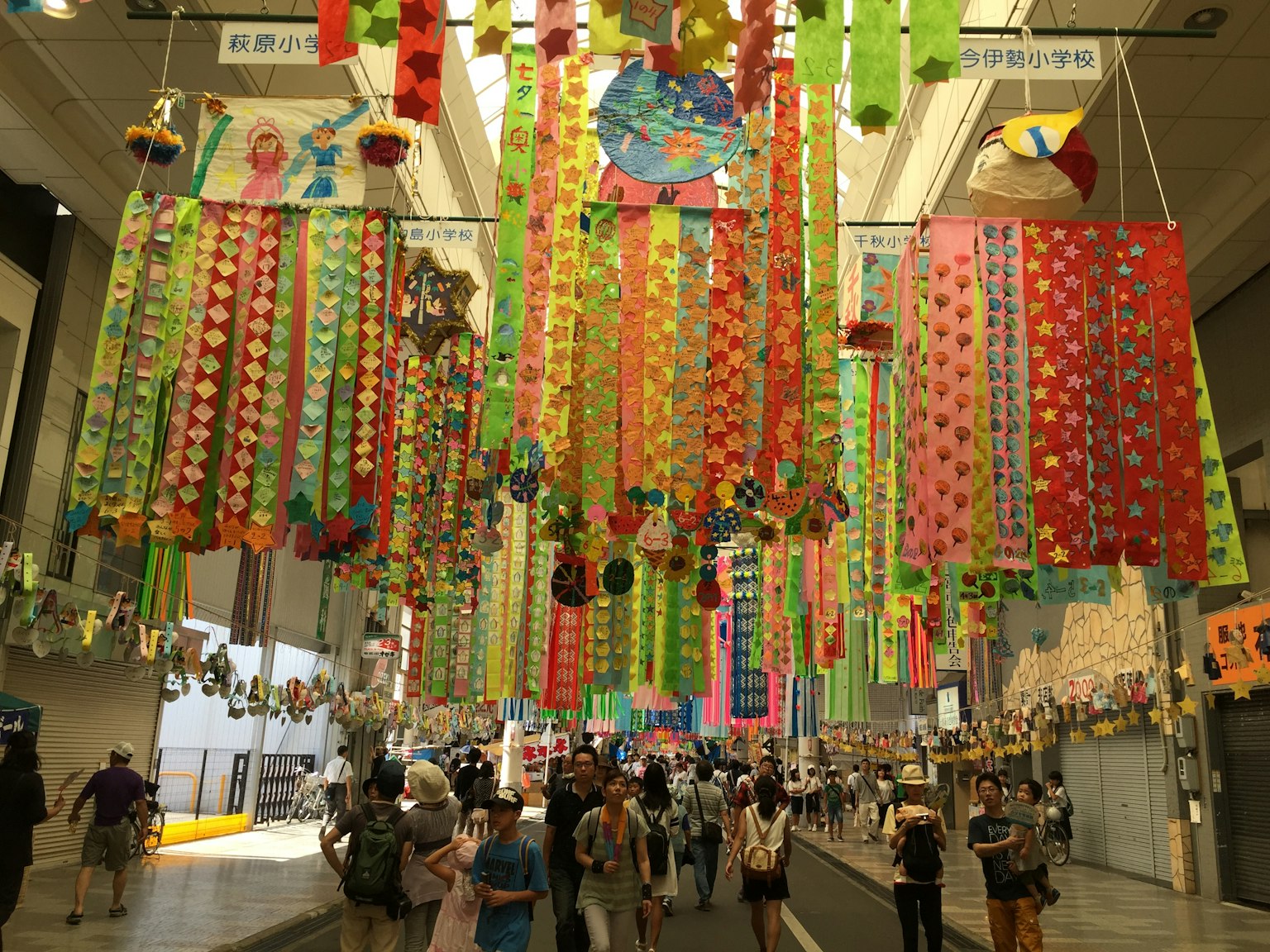 Vibrant event space adorned with colorful decorations hanging from the ceiling
