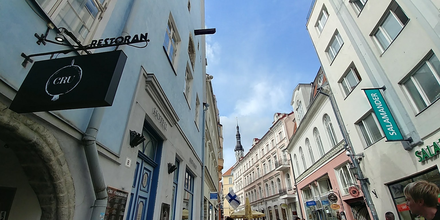 Narrow street view featuring buildings and a sign