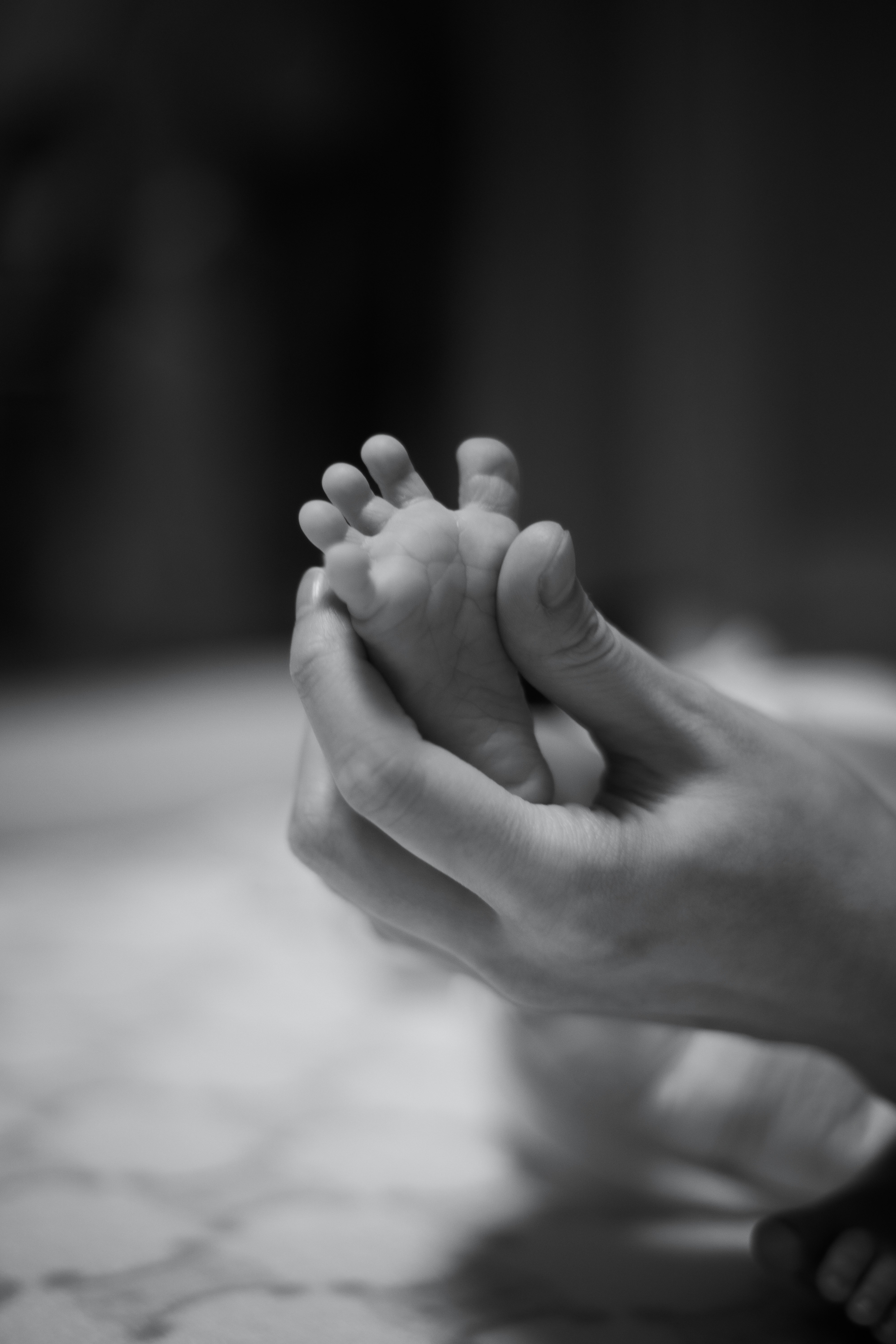 hands gently supporting bare feet