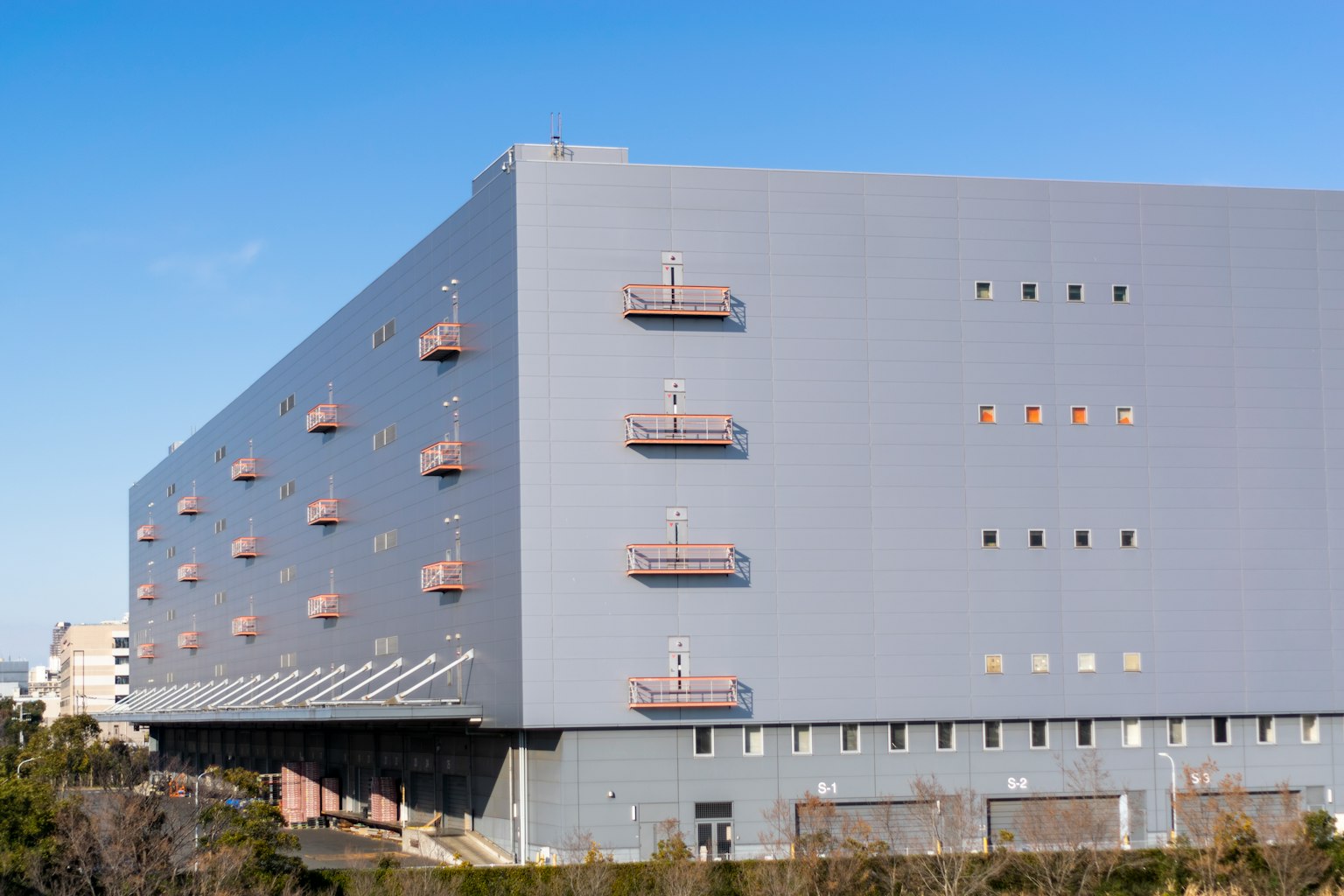 Grande edificio grigio con più balconi visibili