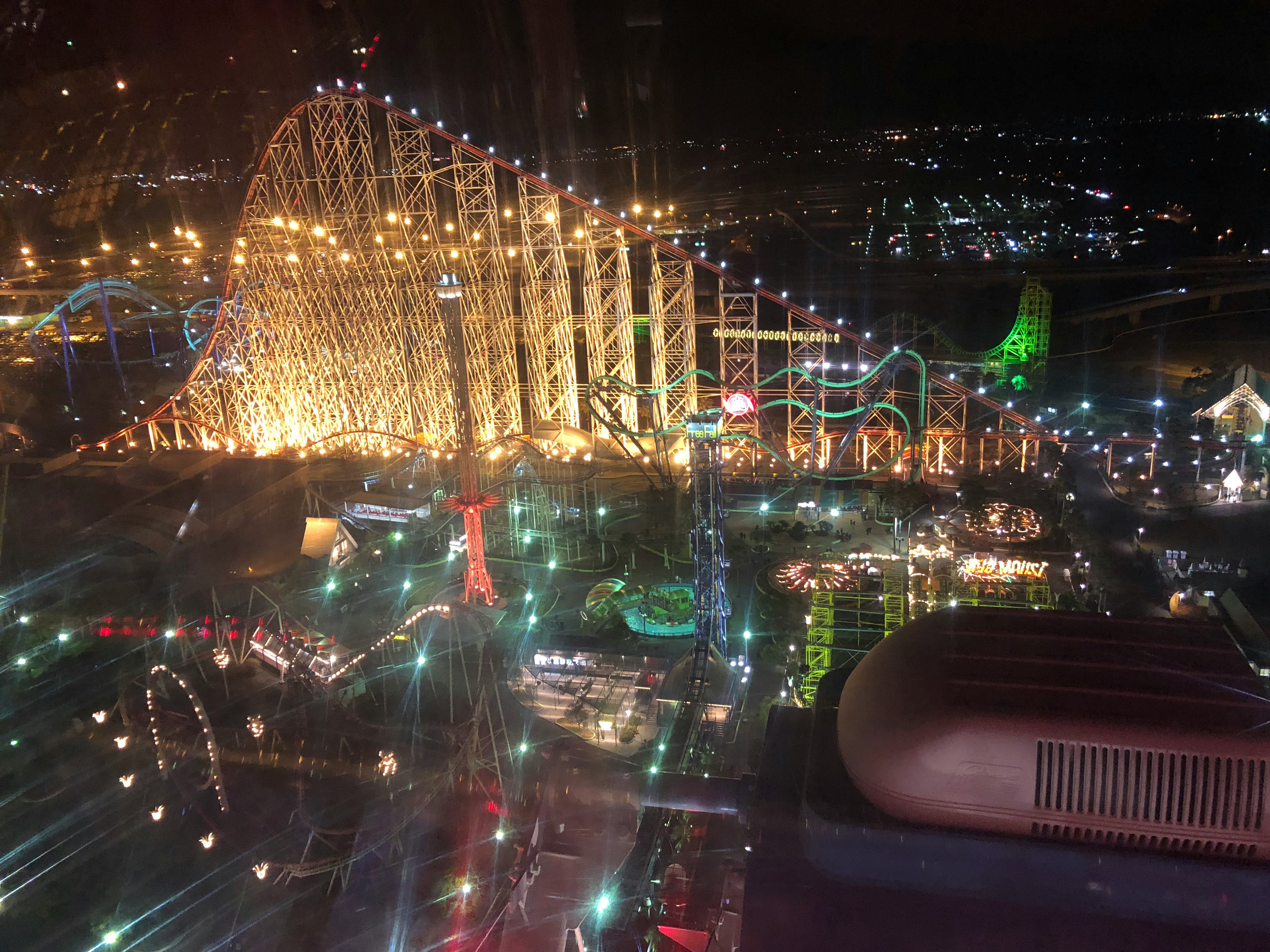 night amusement park rides and Ferris wheel light displays