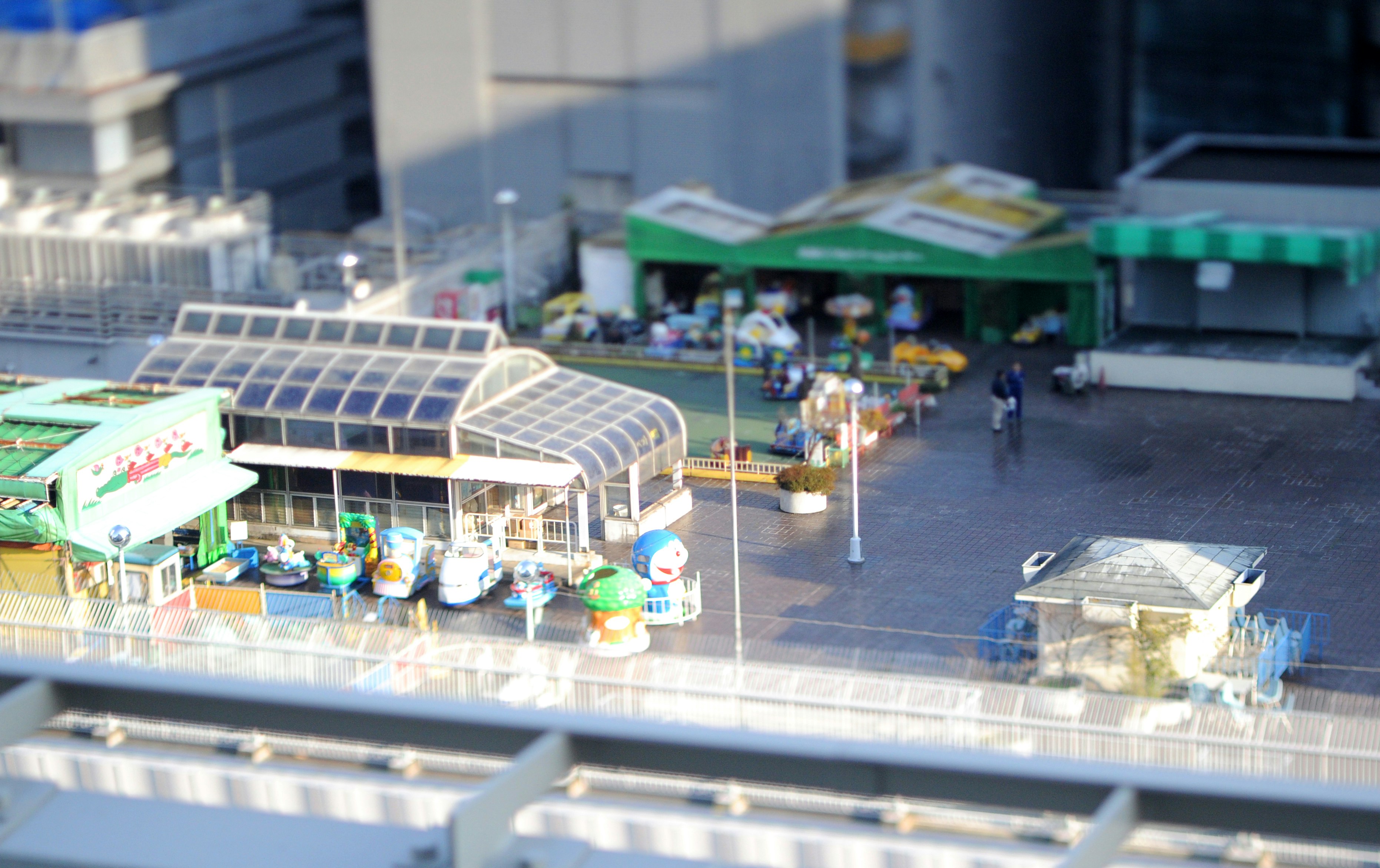 Aerial view of a covered market walkway with stalls and shops