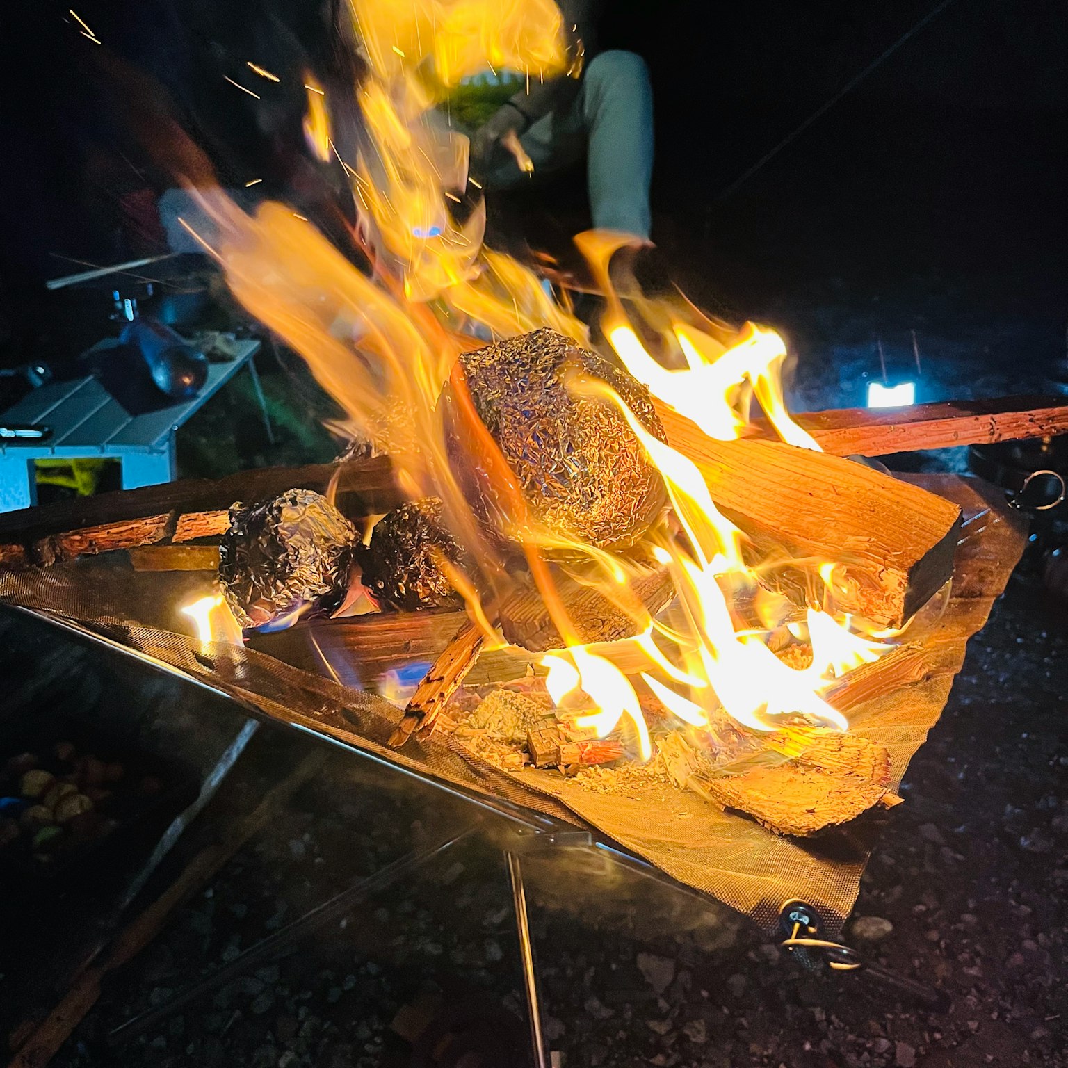 A vibrant campfire with bright flames and glowing embers