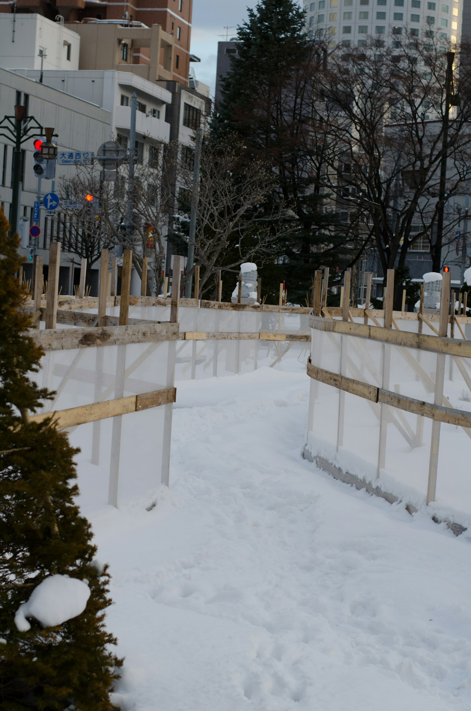 Snow-covered walkway with wooden fences
