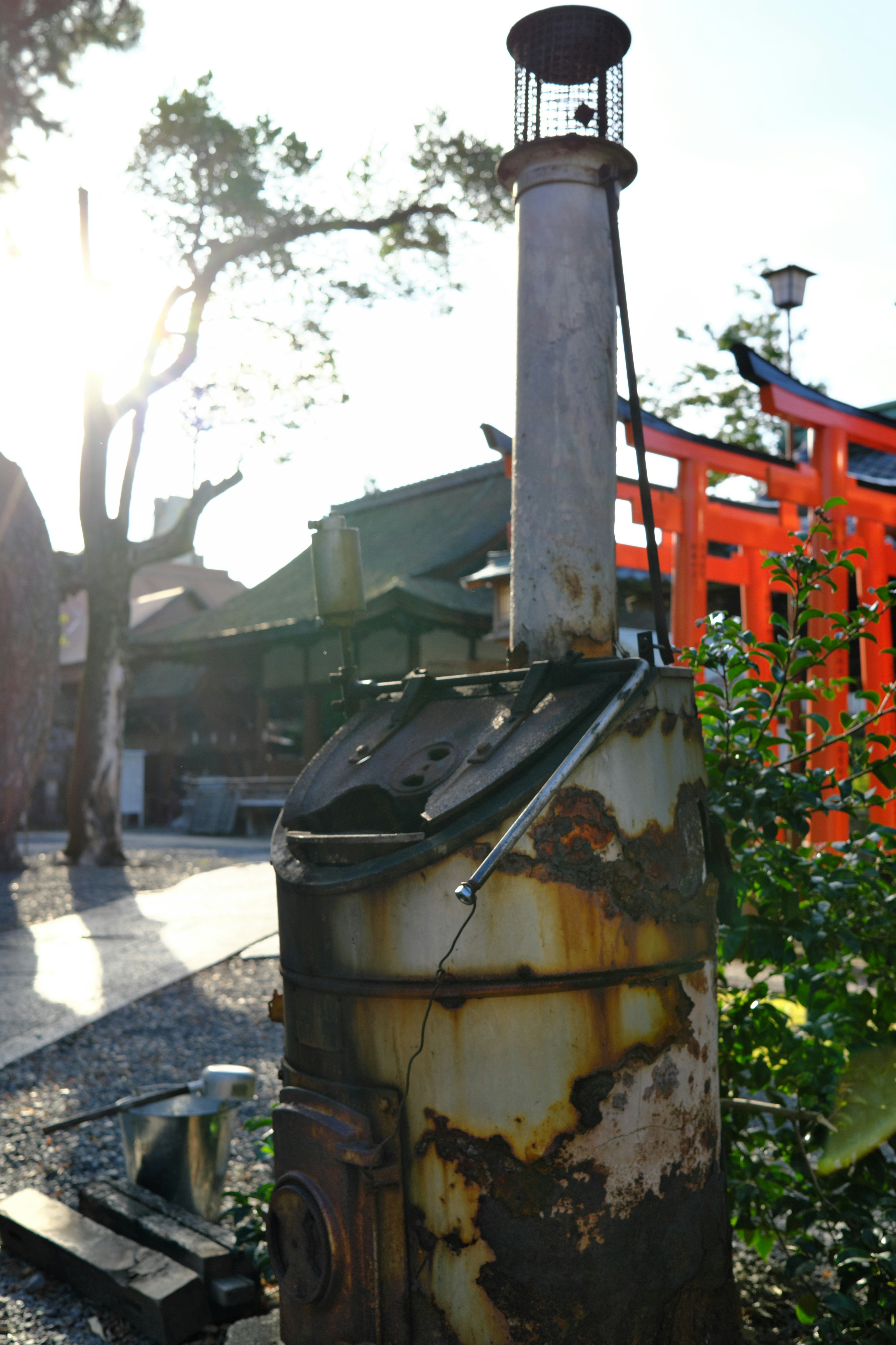 temple water basin and stone path beside a red torii gate