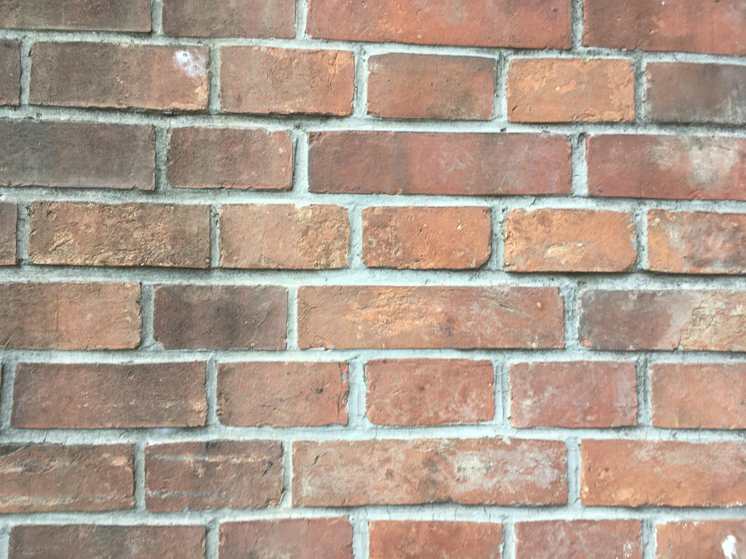 Texture d'un mur en briques rouge-brun
