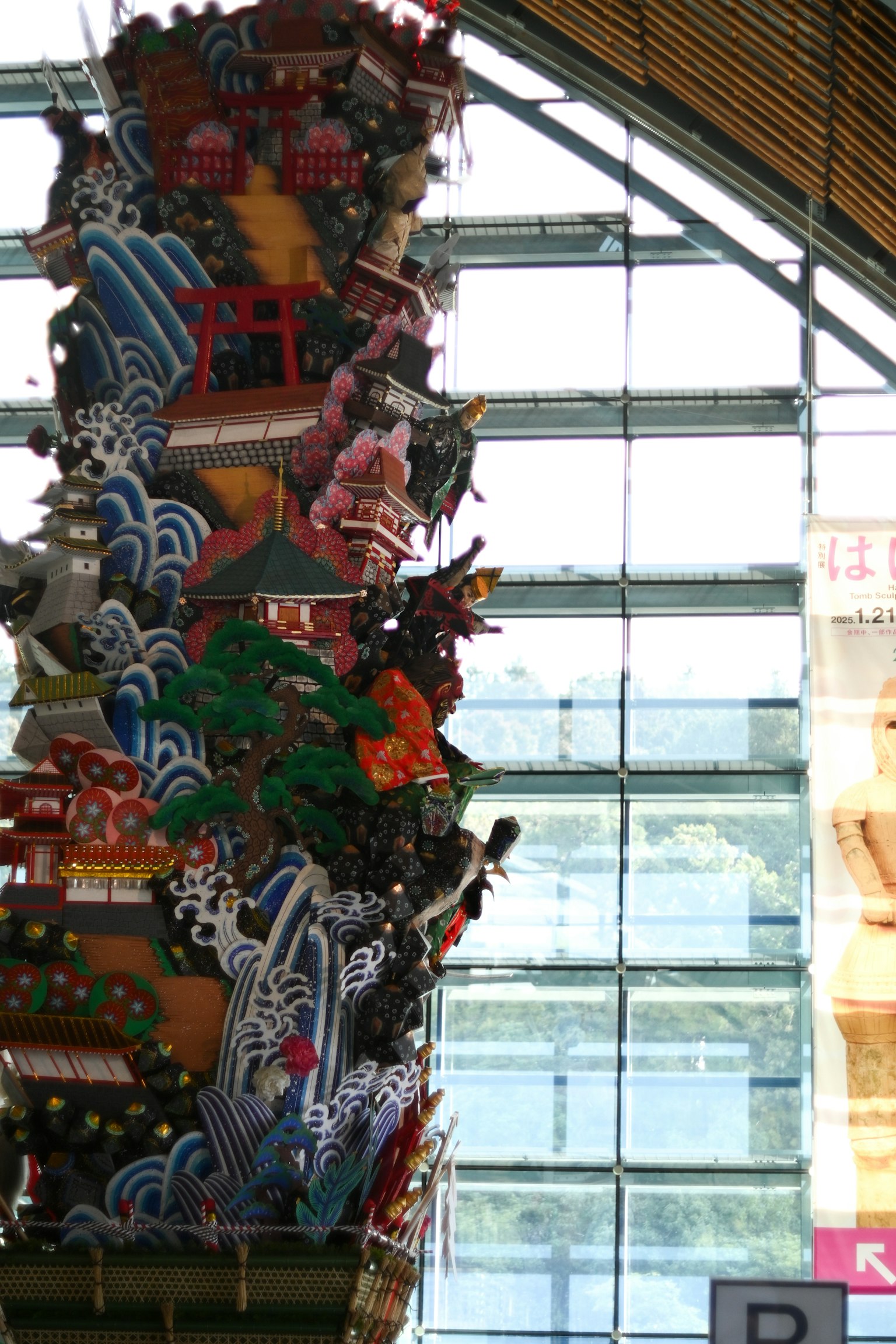 A colorful decorated pillar stands near a window