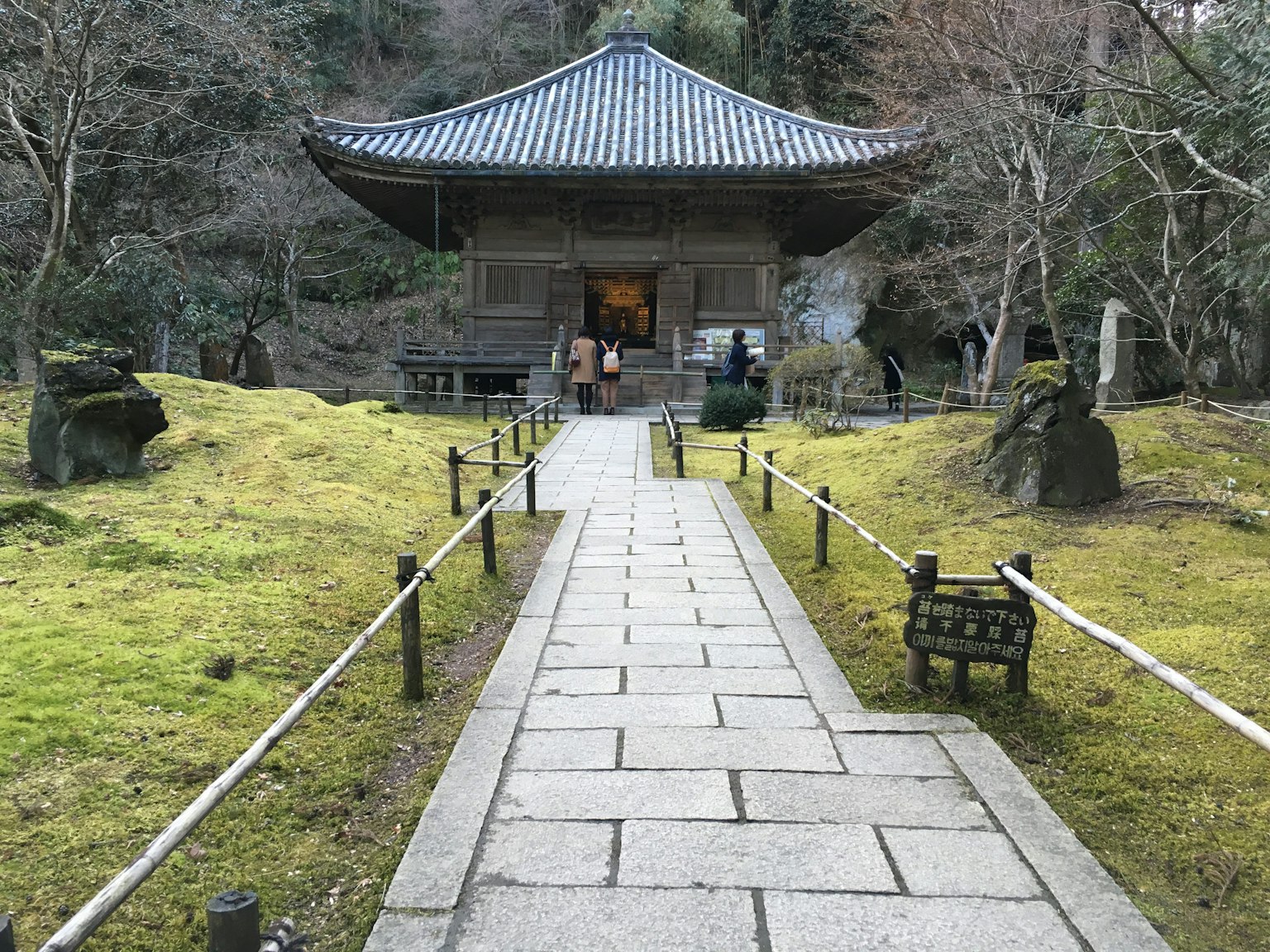 Path leading to a traditional Japanese temple surrounded by a serene garden