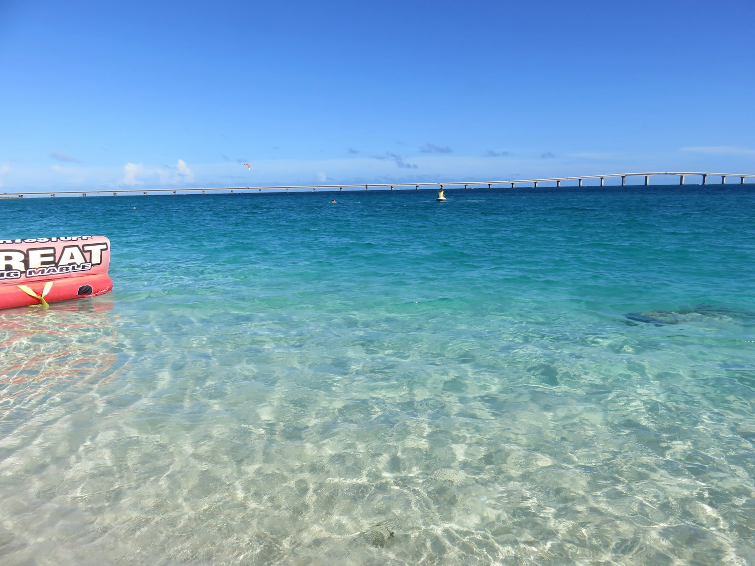 Beautiful beach scene with clear water and blue sky Lifebuoy resting on the shore