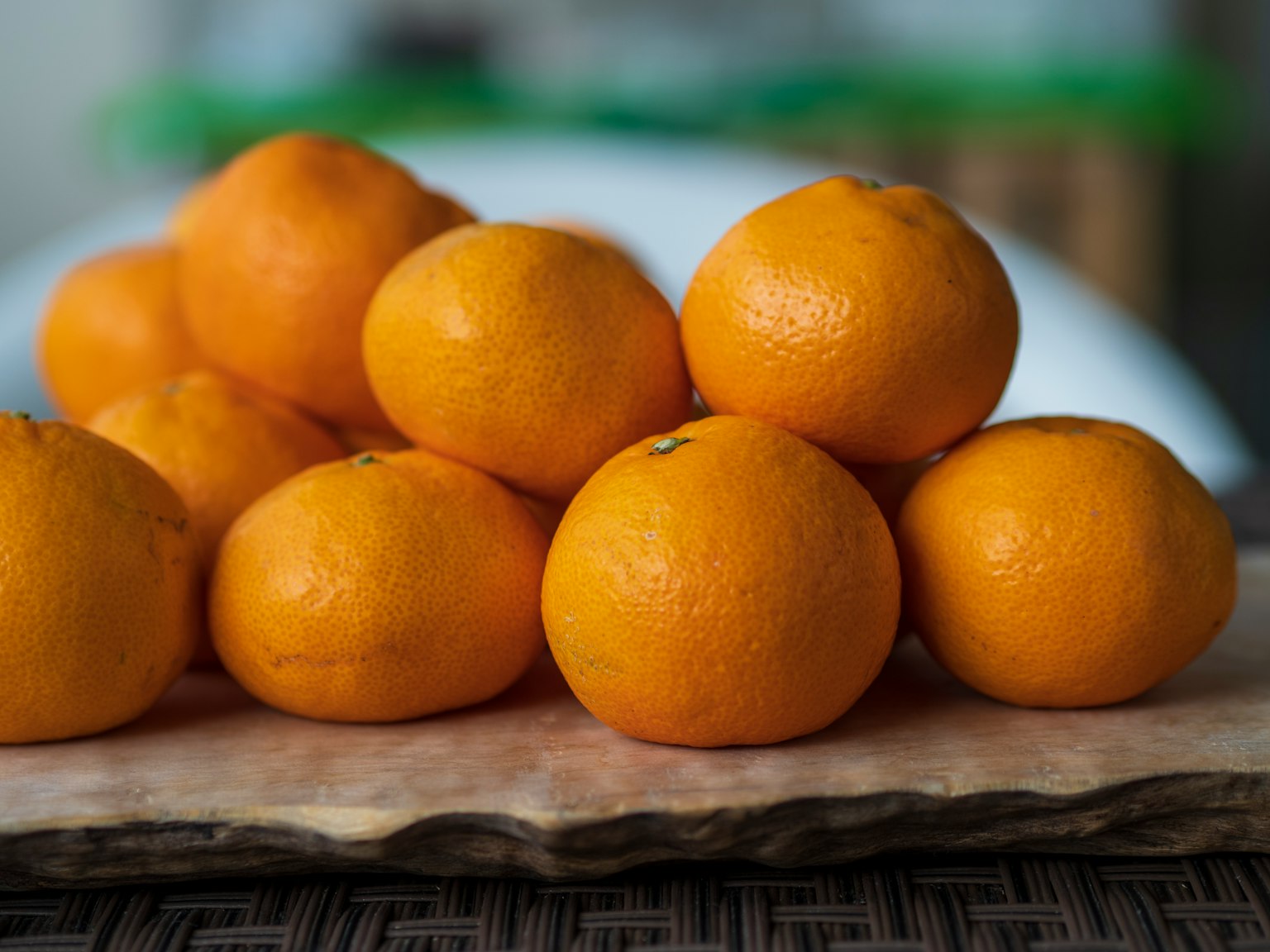 Una pila de mandarinas naranjas brillantes dispuestas sobre una tabla de madera